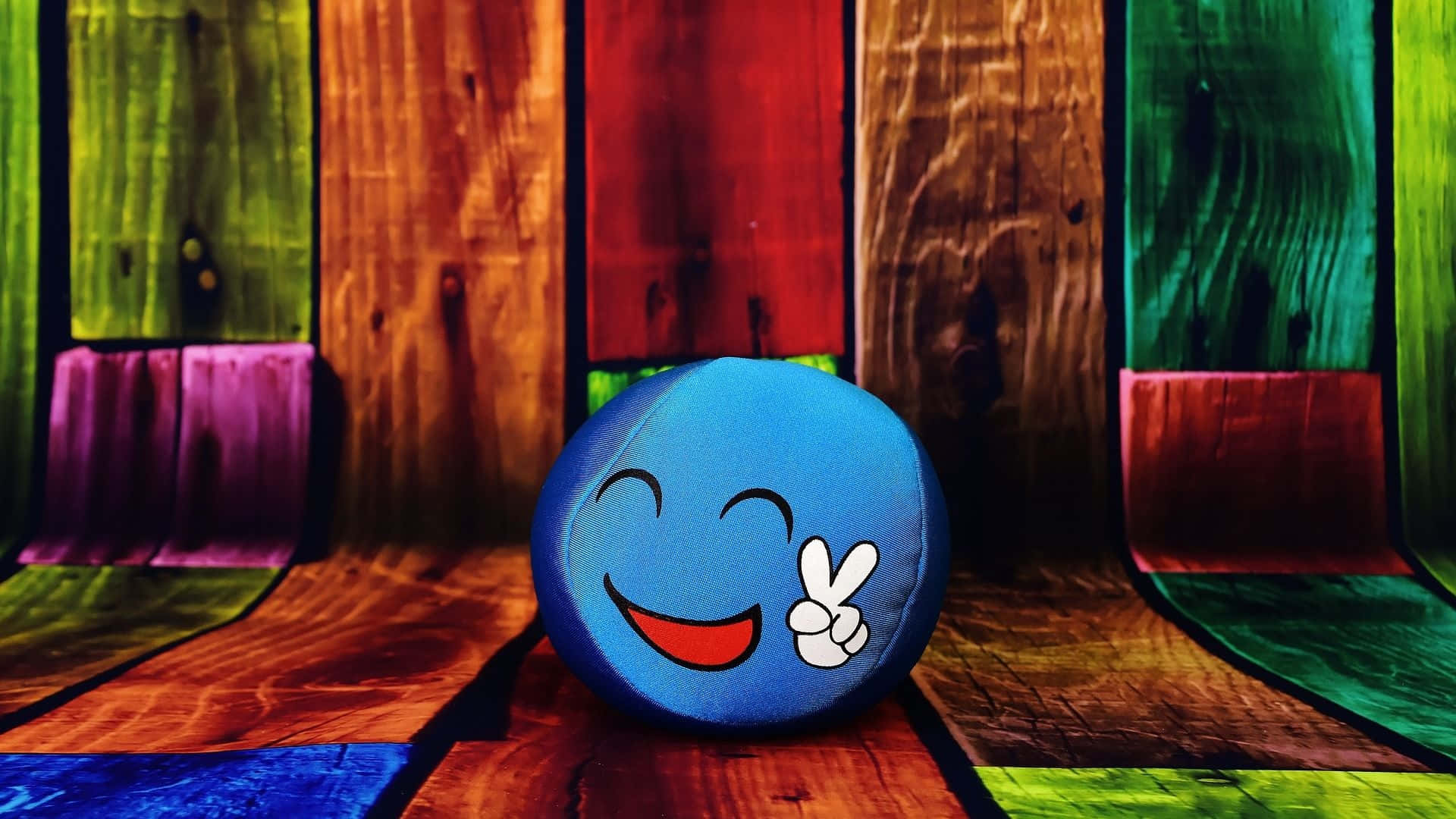 Colorful Smiley Faceon Wooden Background Wallpaper