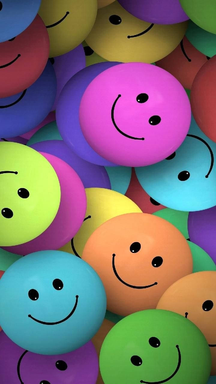 Caption: Multicolored Array of Smiley Faces Wallpaper