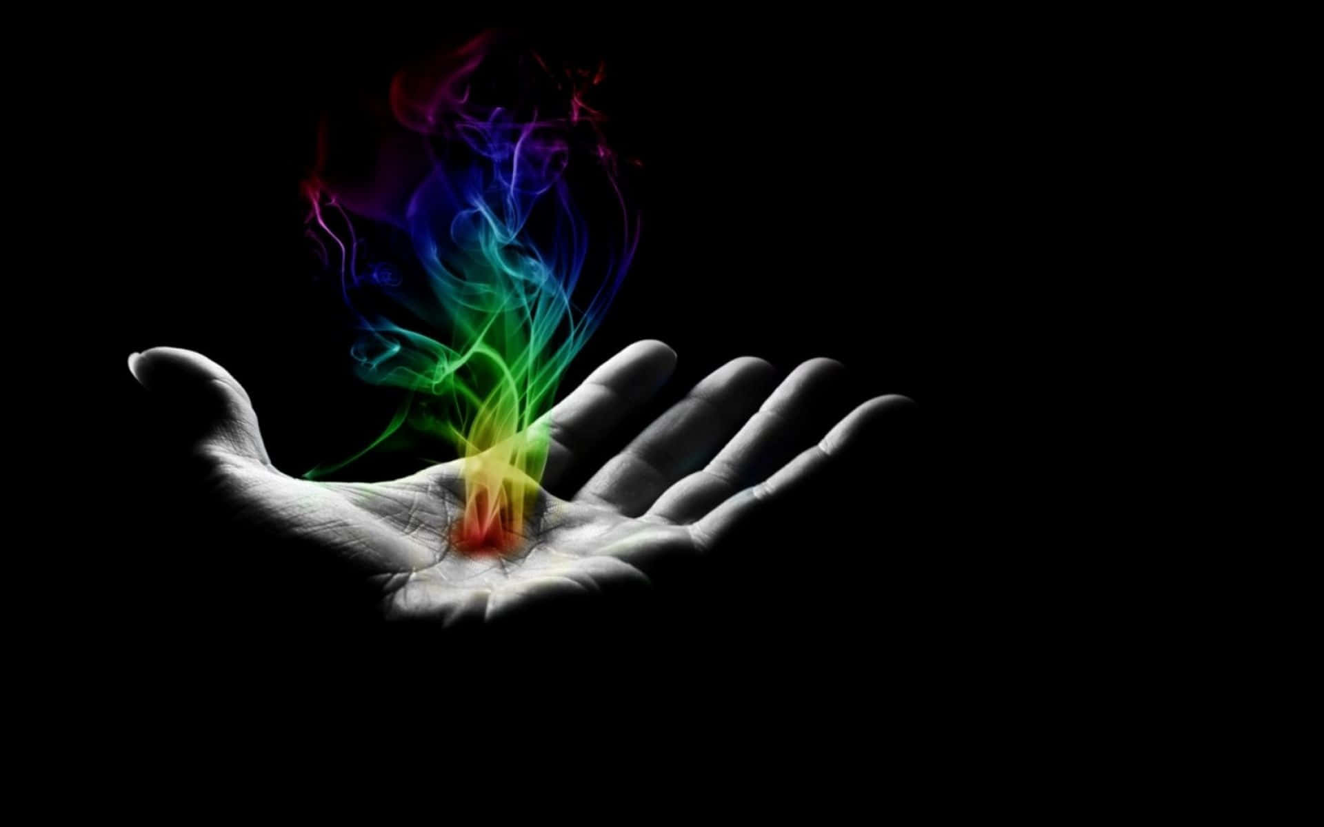 En hånd med en regnbuefarvet flamme i det Wallpaper