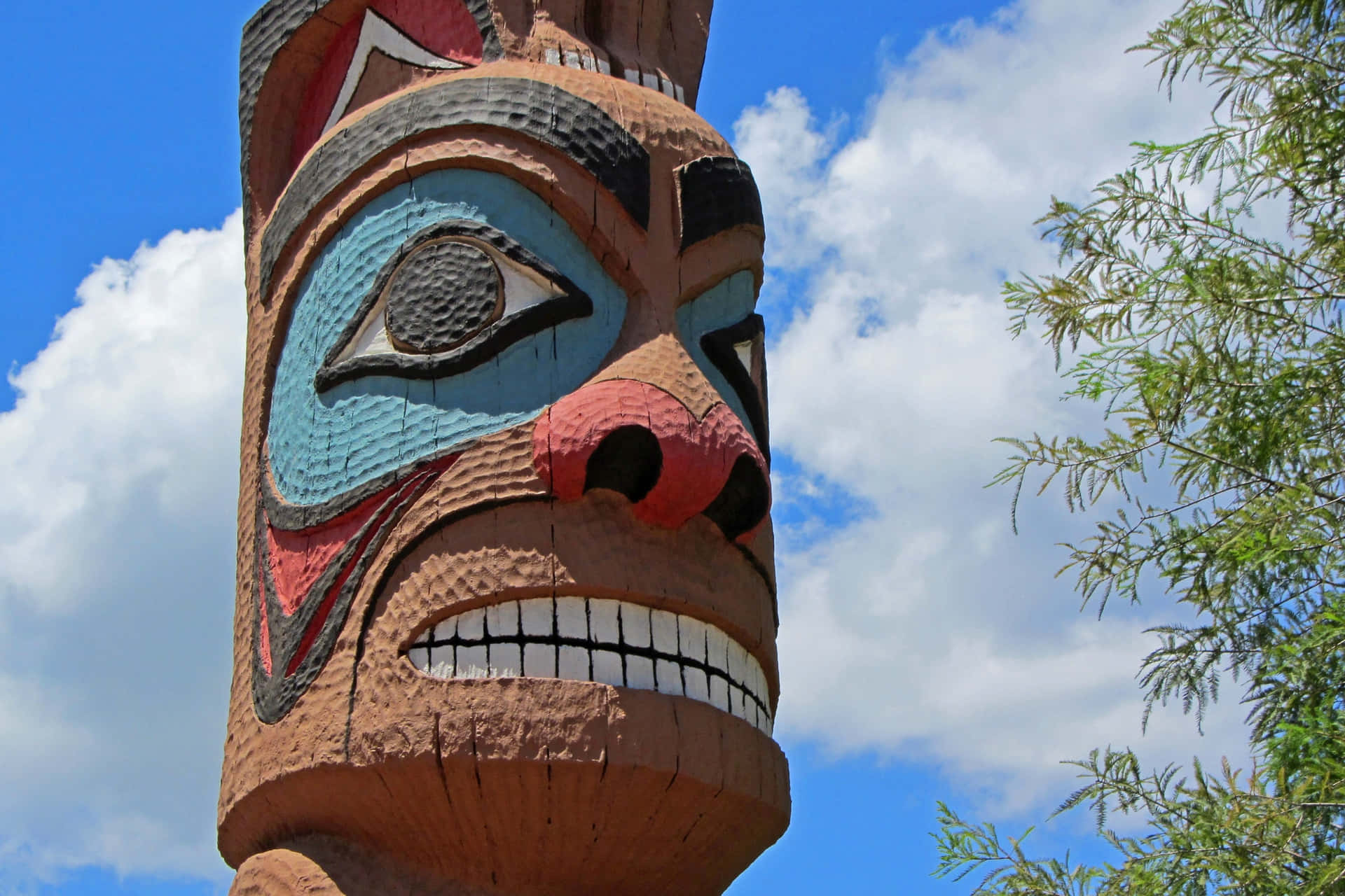 Colorful Tiki Totem Pole Sky Background Wallpaper