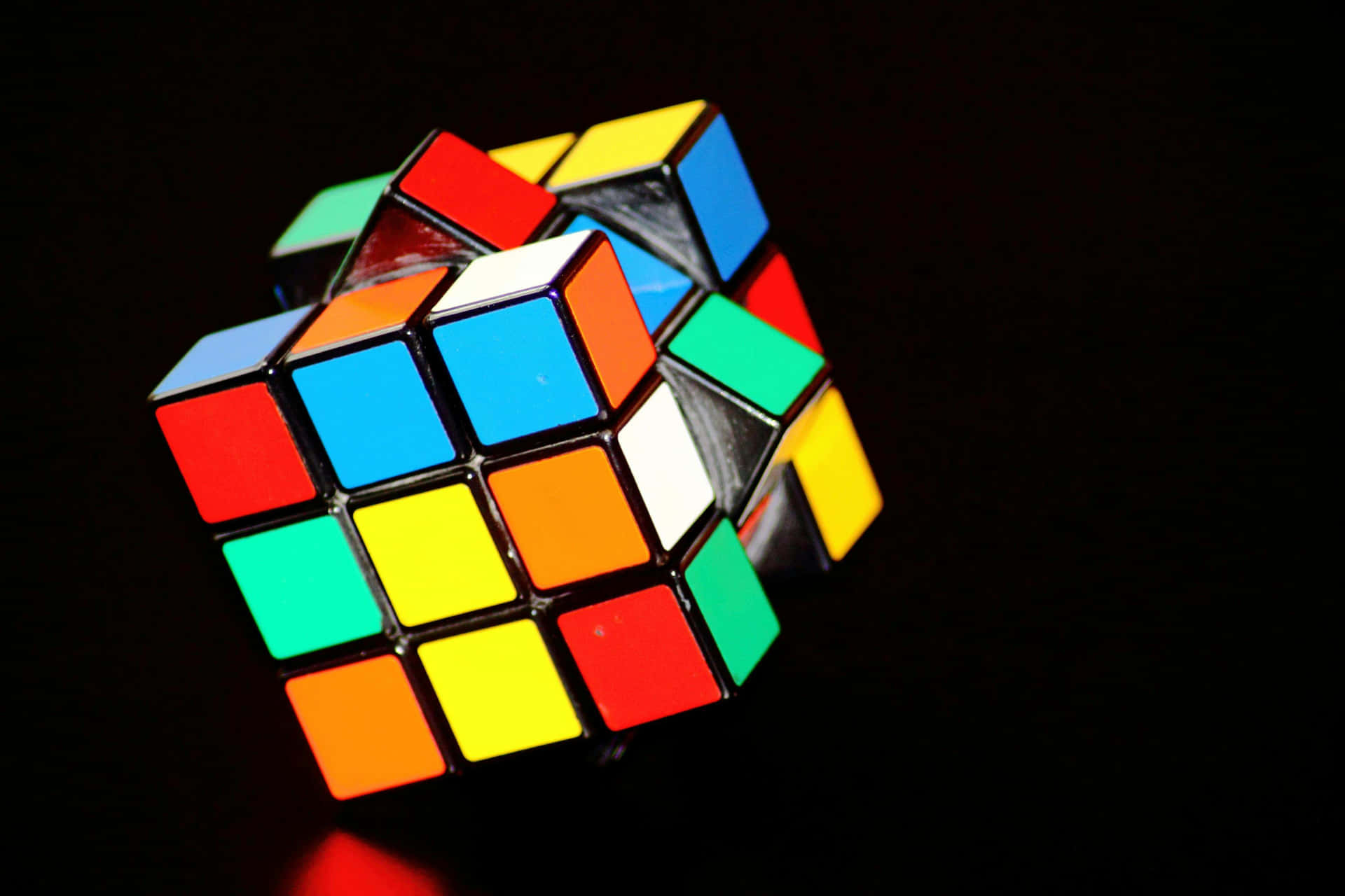 Colorful Unsolved Rubiks Cubeon Black Background Wallpaper