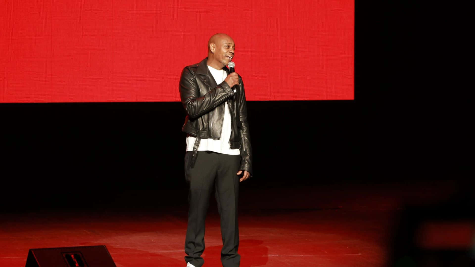 Comedian Dave Chappelle Delivering A Powerful Stand-up Performance Wallpaper
