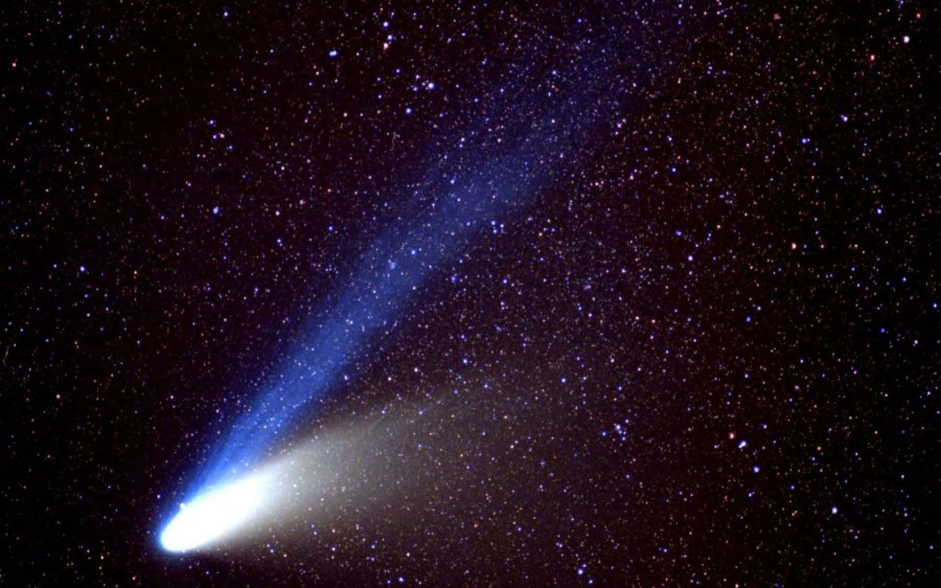 Celestial Show - Stunning Comet Lighting Up the Night Sky Wallpaper