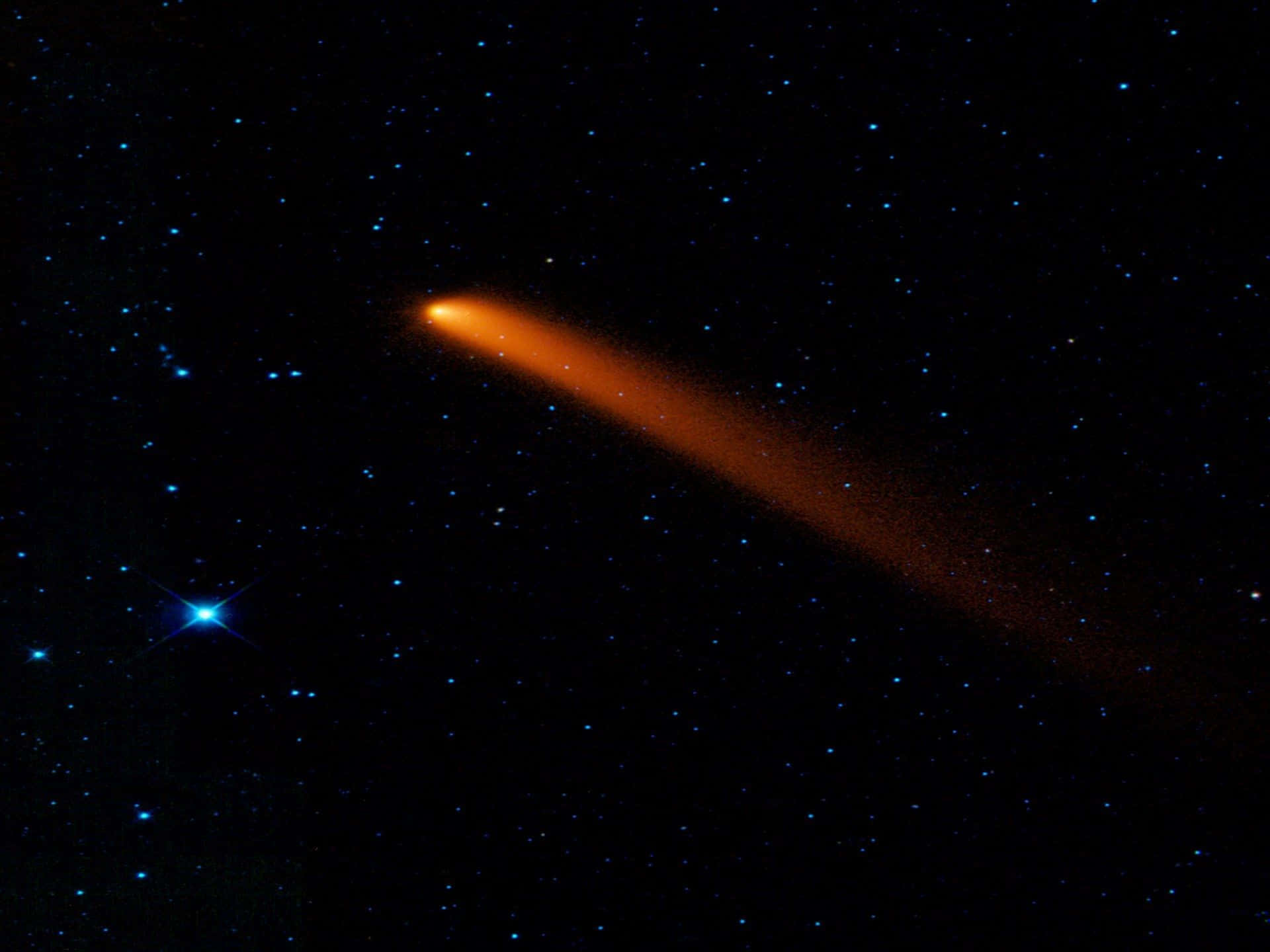 Caption: Stunning Comet Illuminating the Night Sky Wallpaper