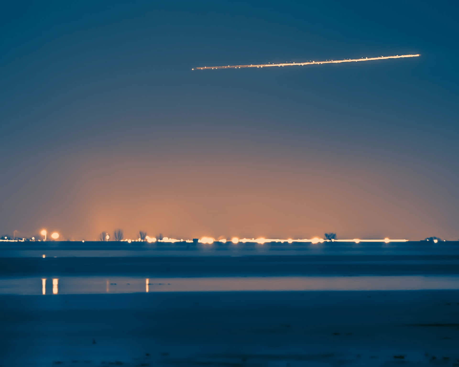 A Stunning Comet Soaring Through the Night Sky Wallpaper