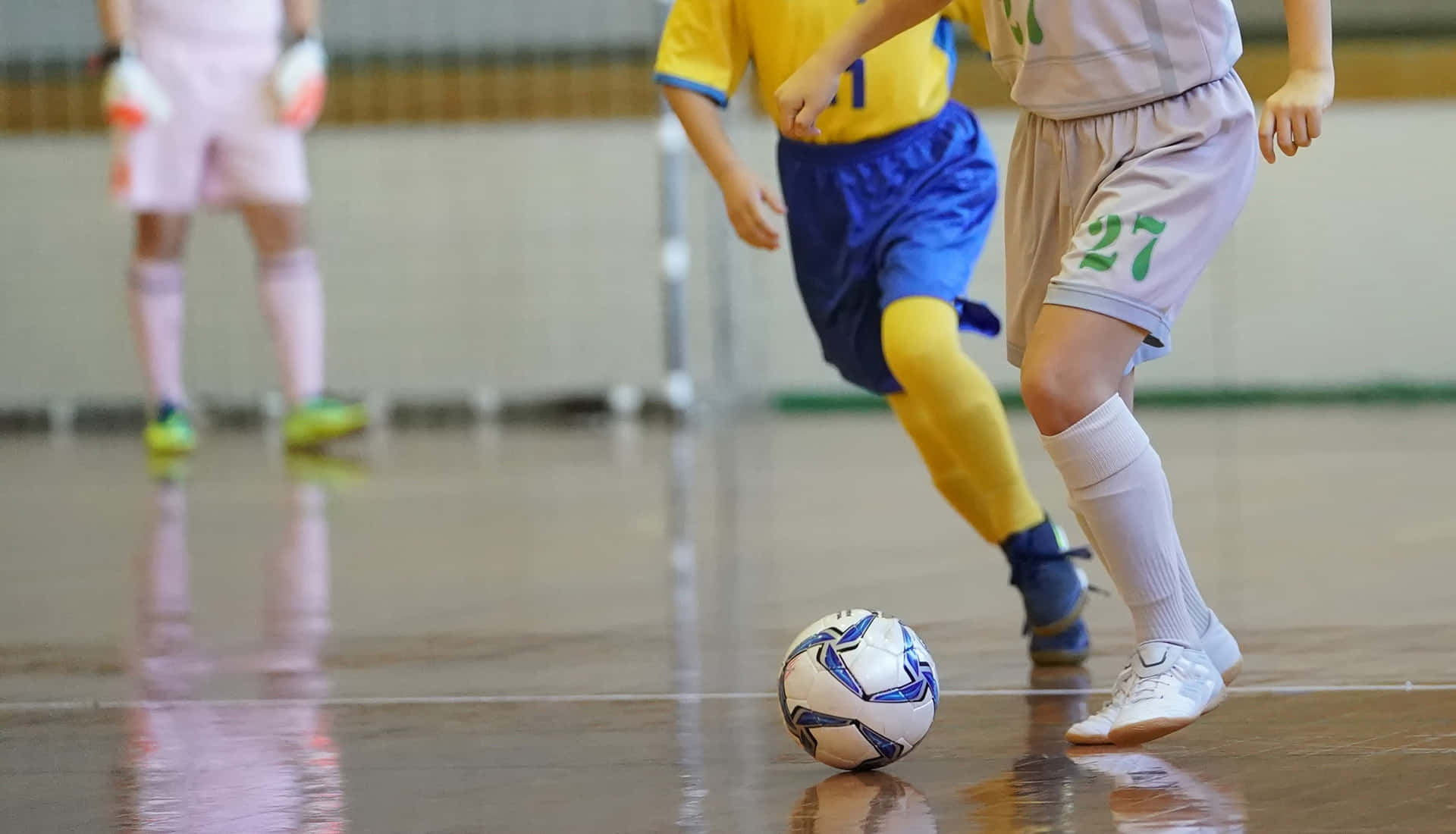 Competitive Indoor Soccer Action Wallpaper