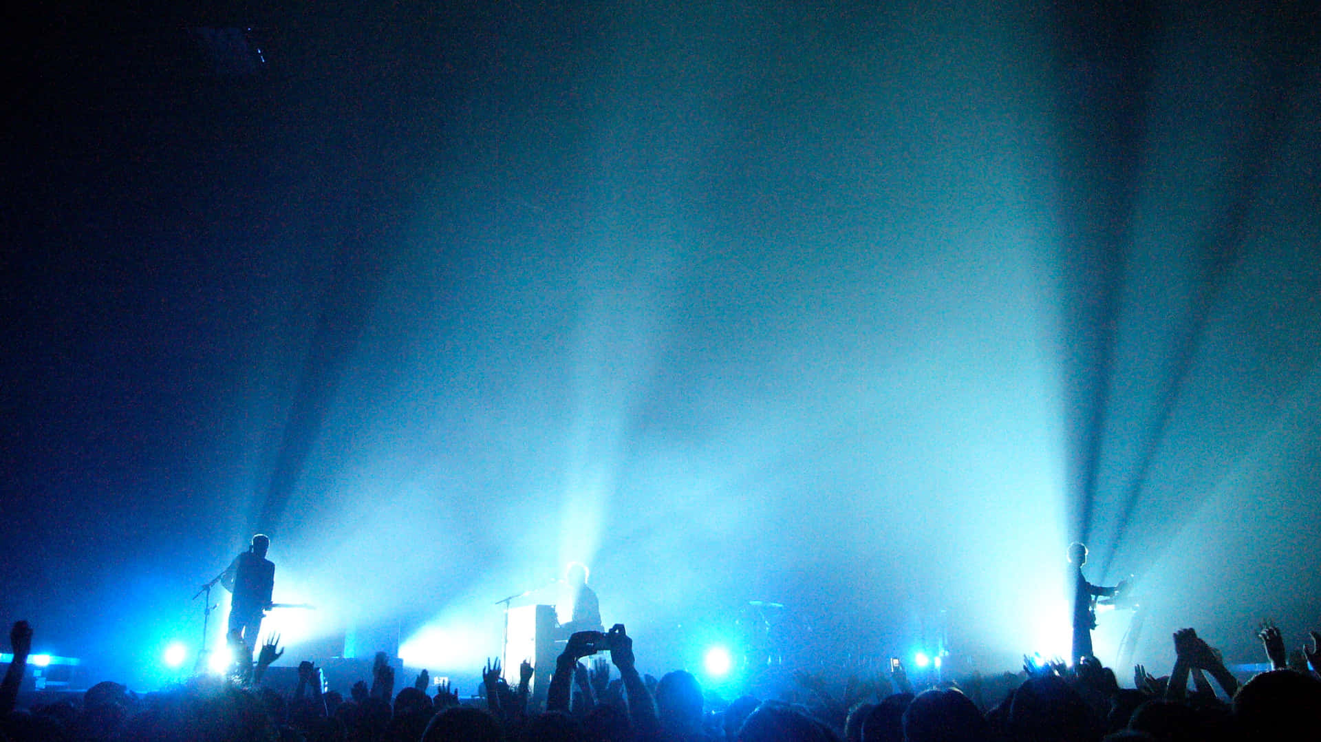 Band Performing With Blue Lights Concert Background