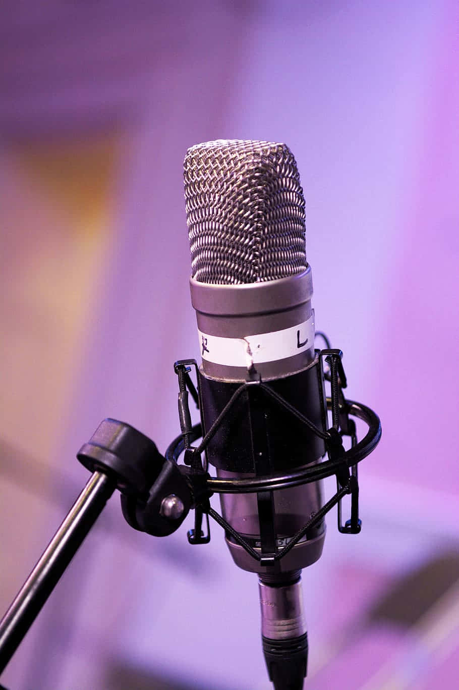 Condenser Microphone Against A Purple Backdrop Wallpaper