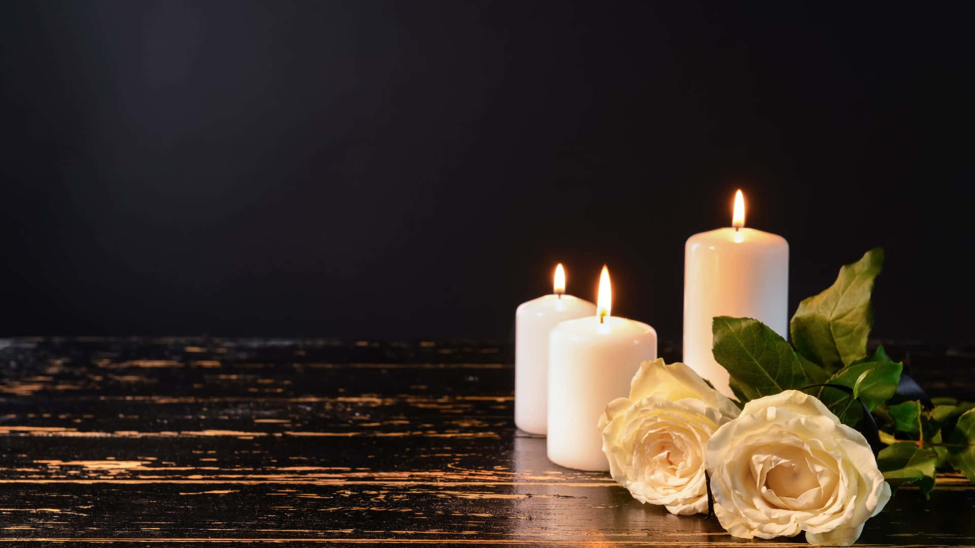 White Candles And Roses On A Wooden Table