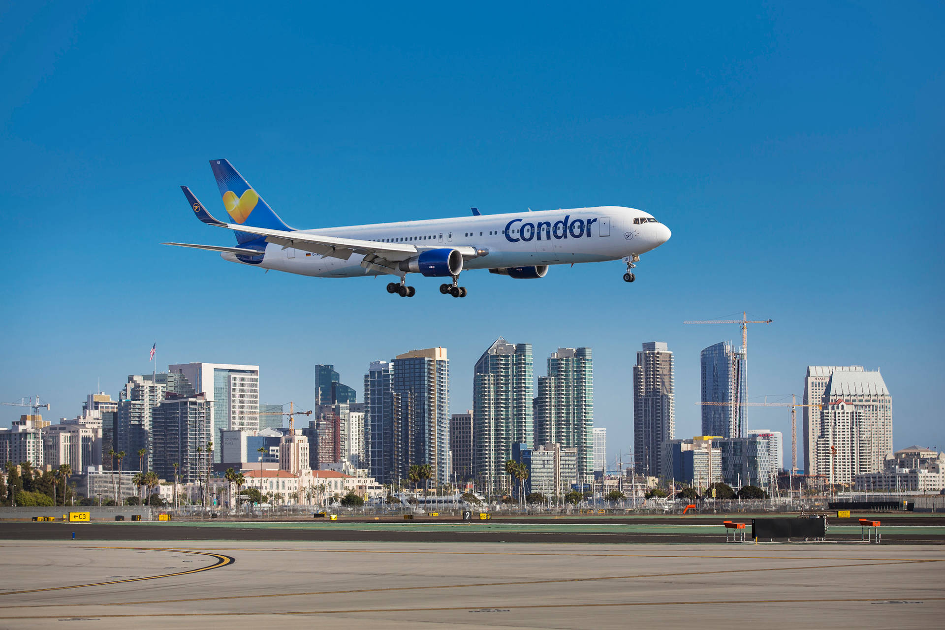 Condor Airlines Flying Above The Skyline Wallpaper