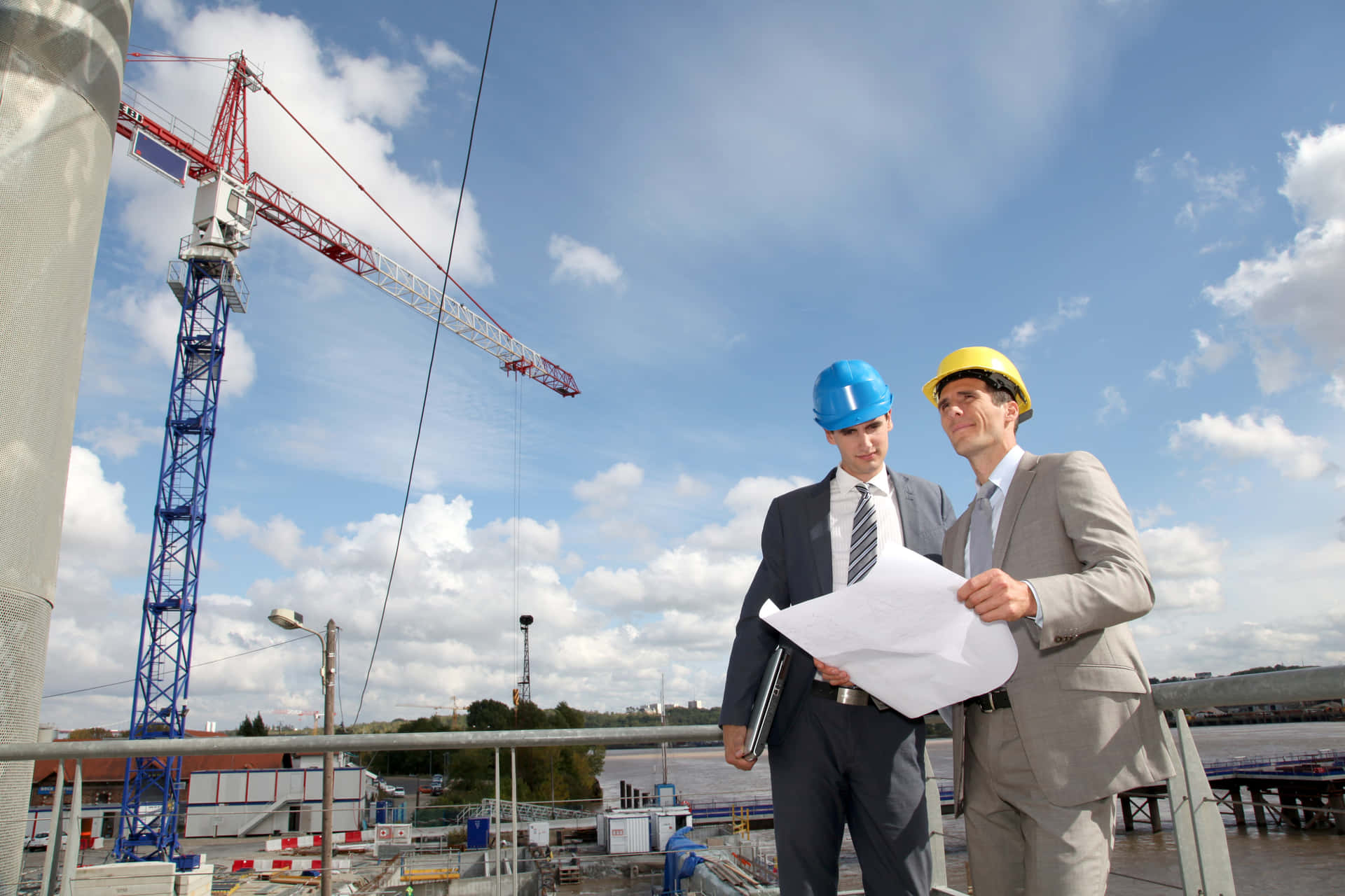 Two Construction Workers Standing On A Construction Site