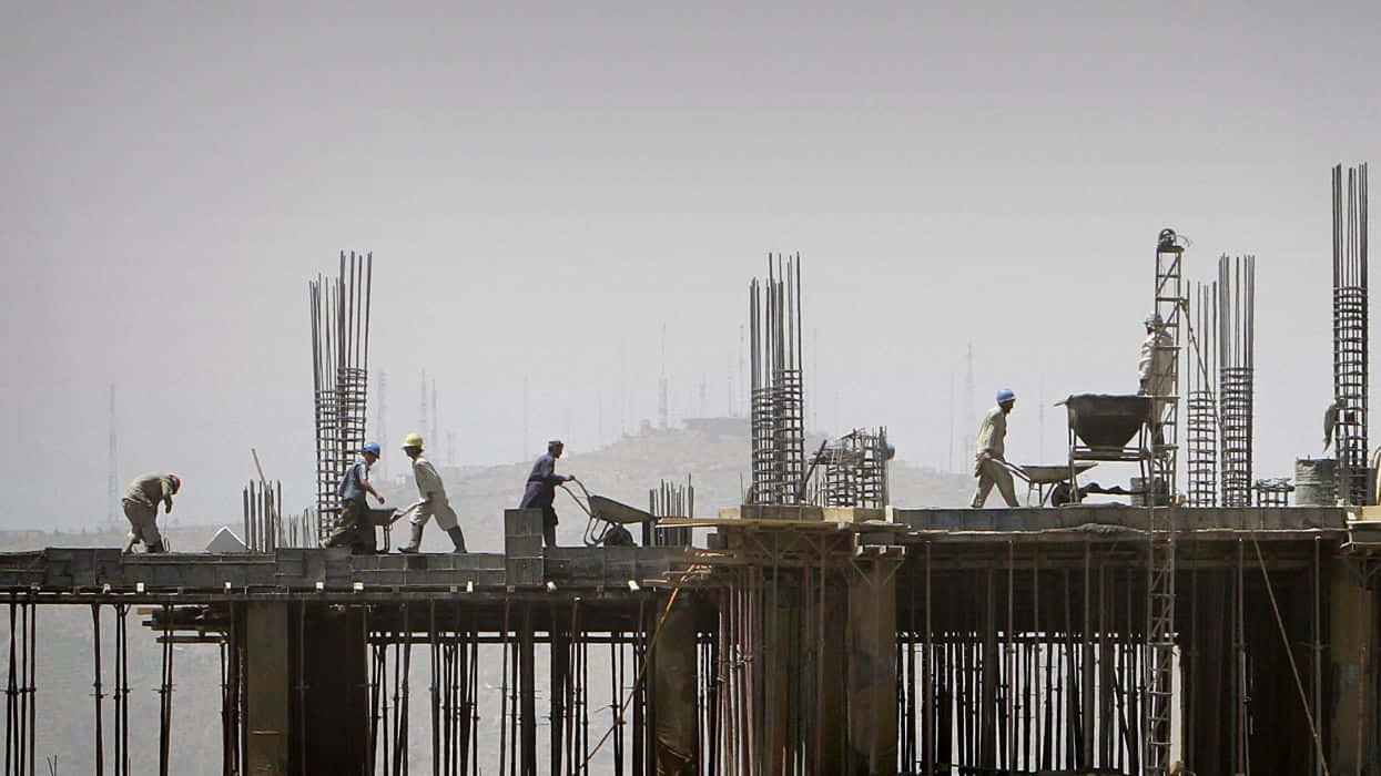 Workers On A Construction Site With A Crane