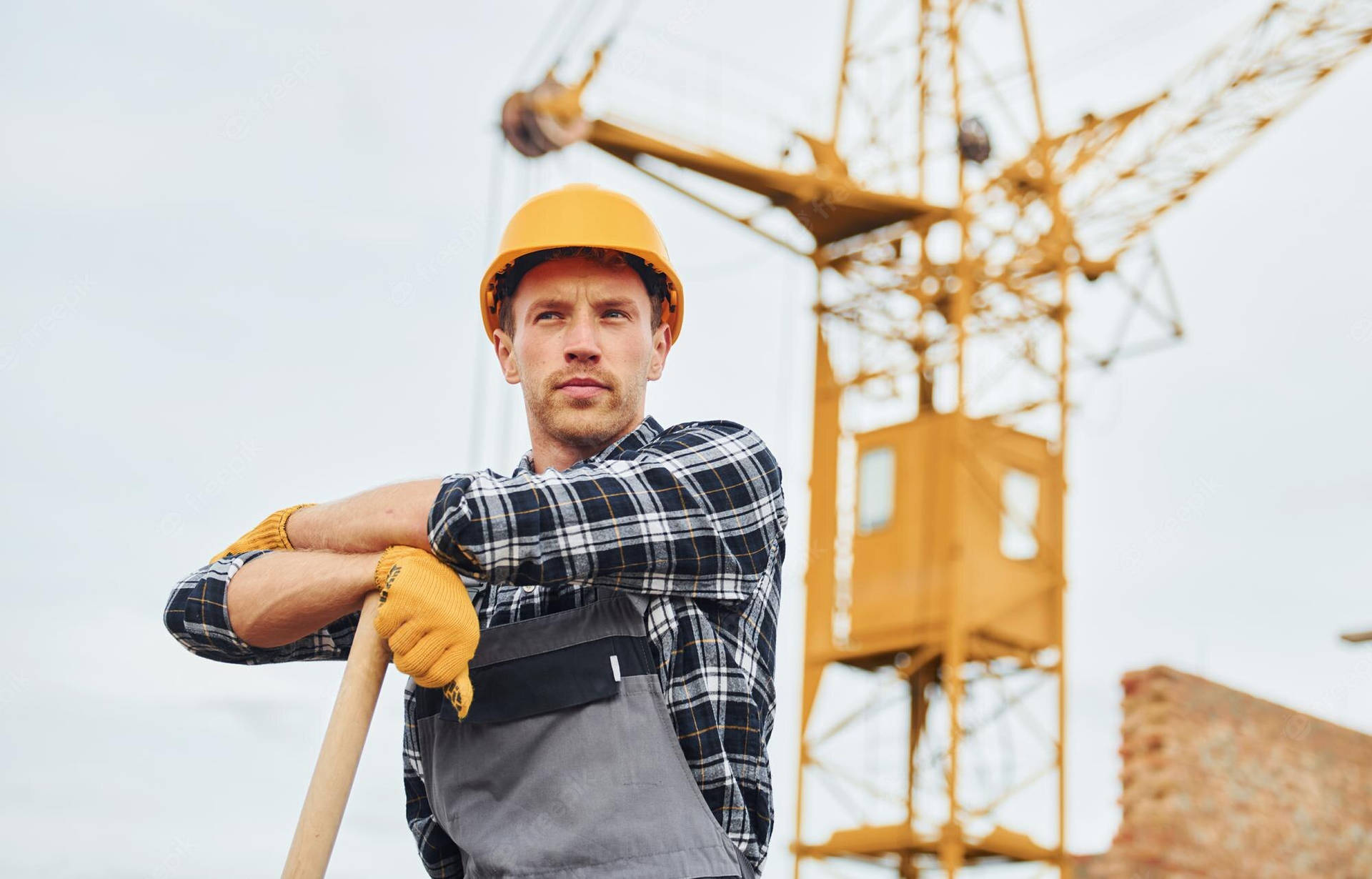 Construction Worker Wearing A Checkerd Longsleeve Wallpaper