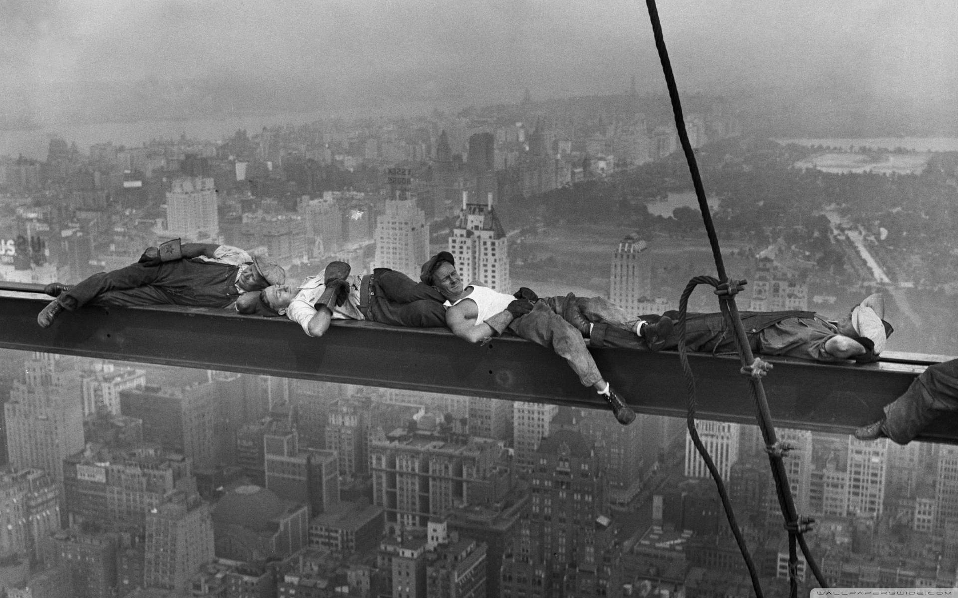 Construction Workers Resting Over The Crane Extension Wallpaper