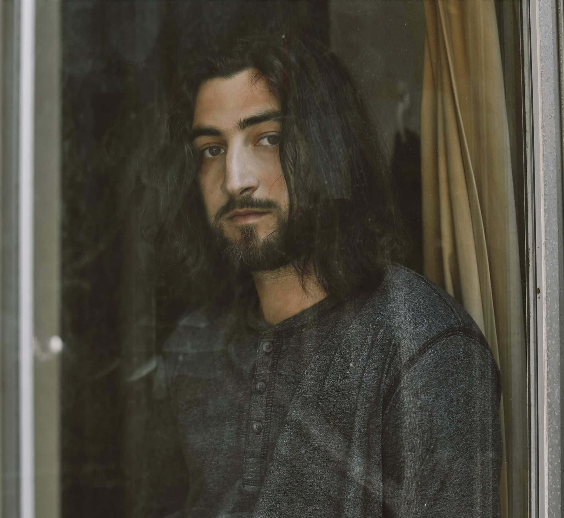 Contemplative Man Behind Glass Wallpaper