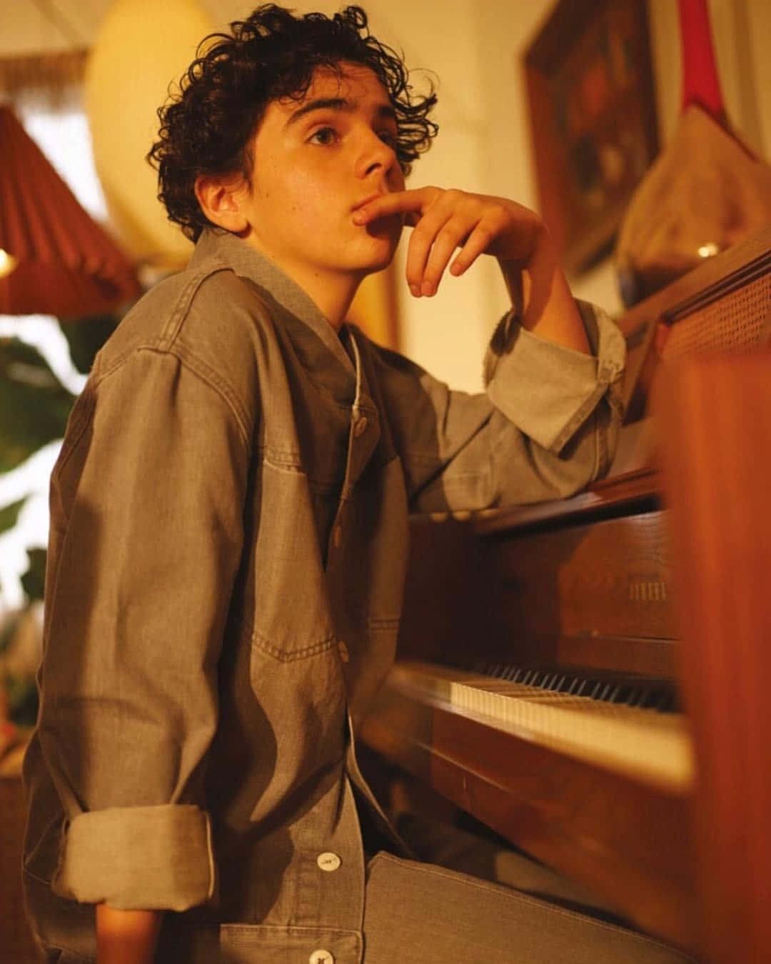 Contemplative Young Manat Piano Wallpaper