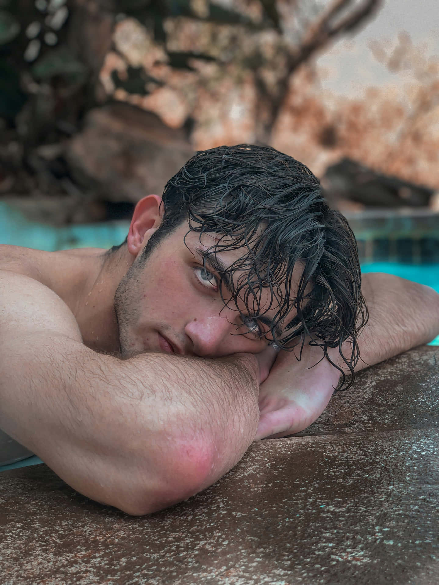 Contemplative Young Manby Poolside Wallpaper