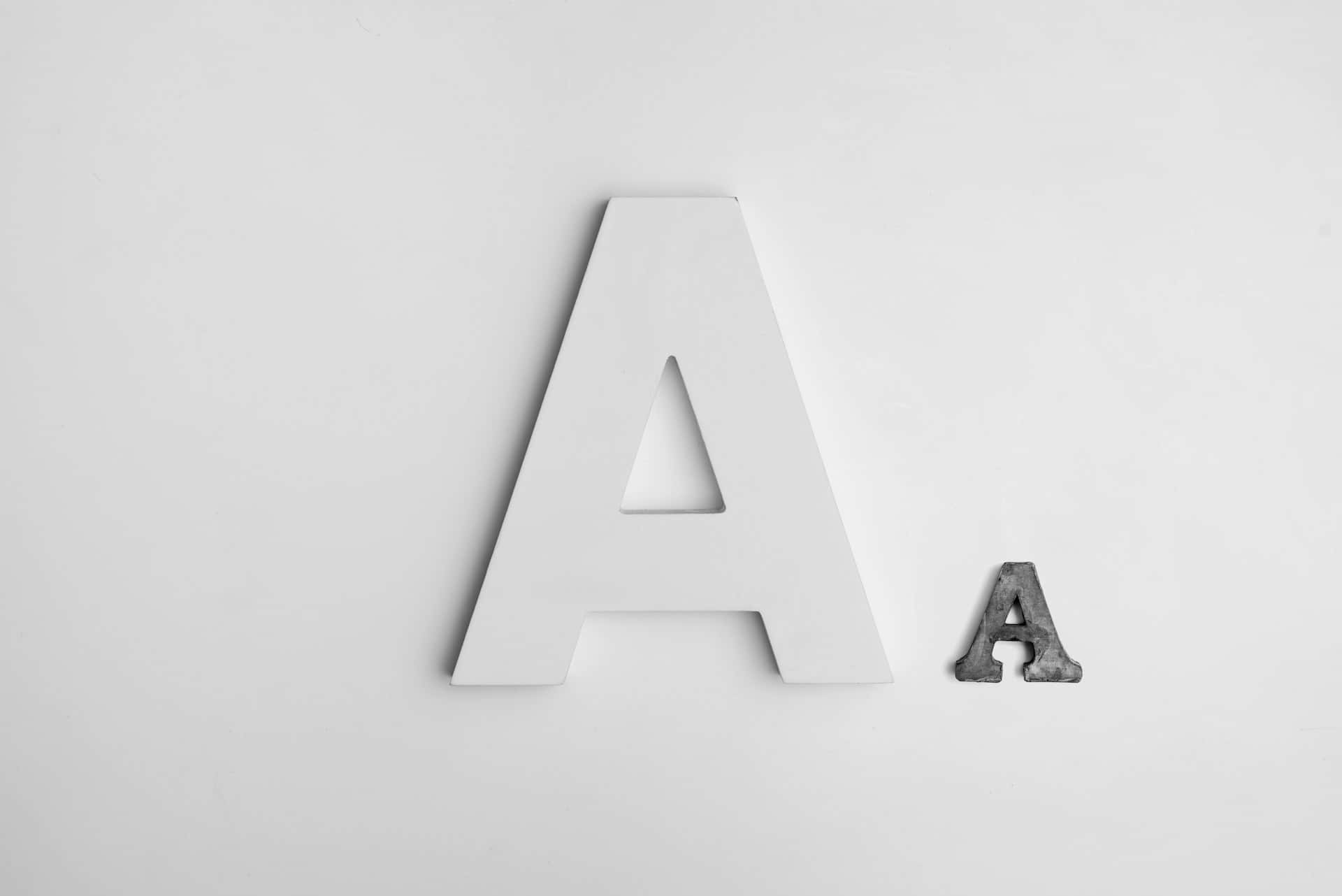 Contrasting Letter A Sizes Minimalist White Background Wallpaper