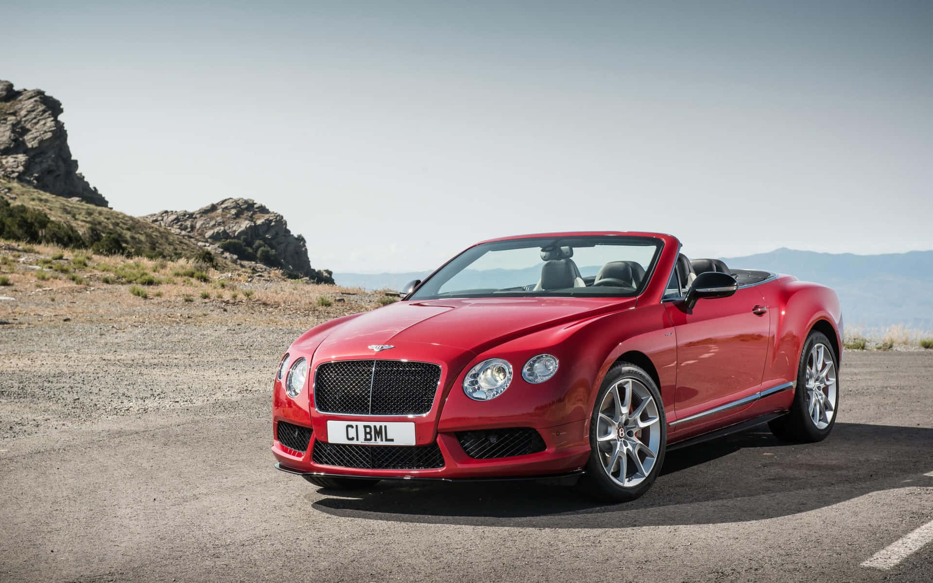 Stunning Red Convertible on a Scenic Road Wallpaper