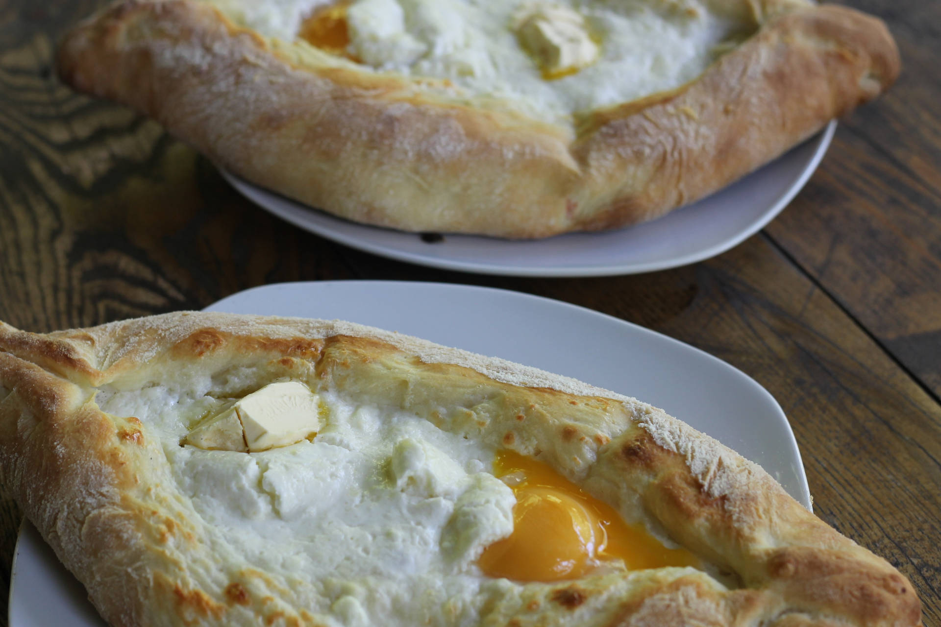 Cooked Khachapuri Breads On Plates Wallpaper
