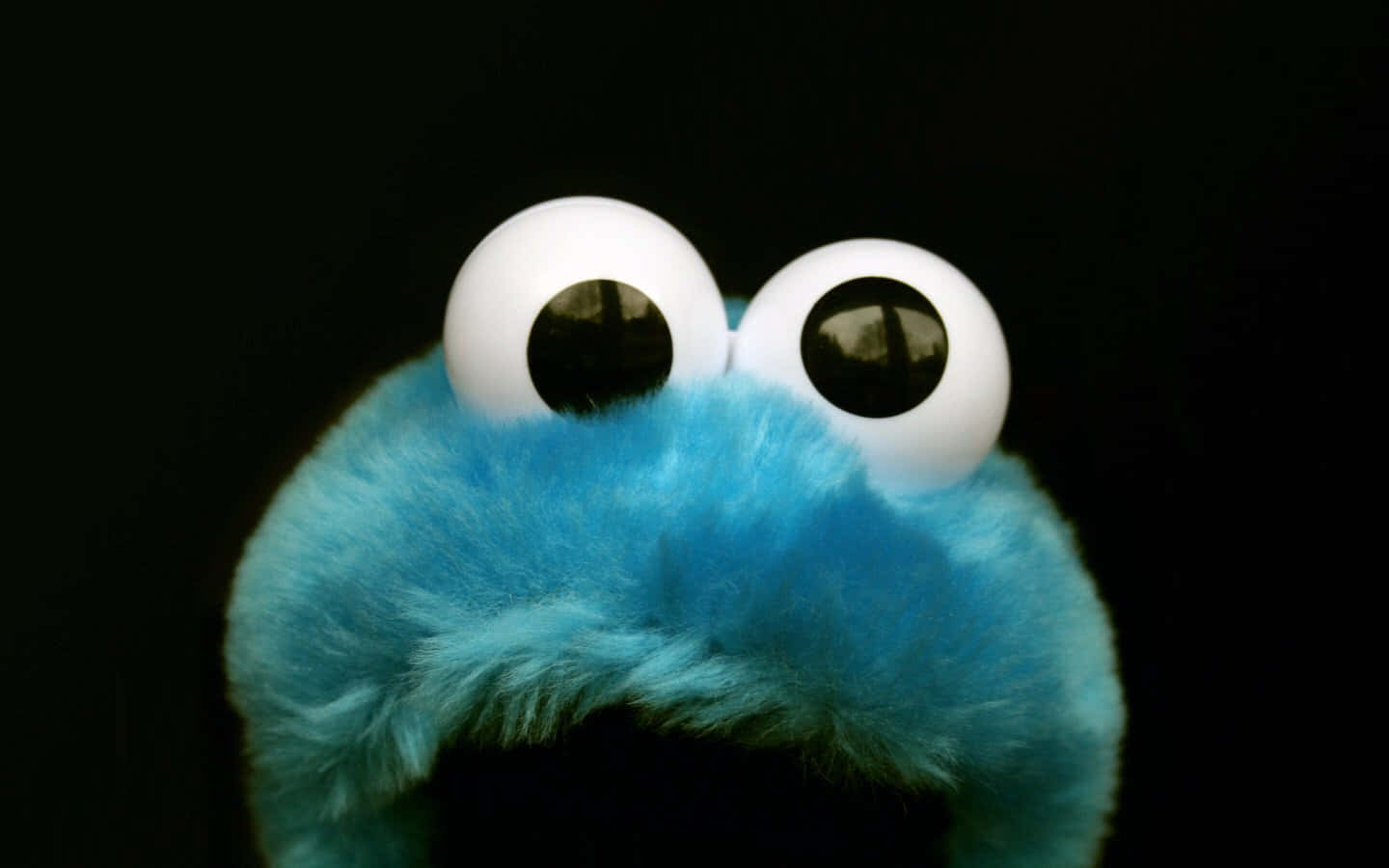 Cookie Monster happily munching on cookies.