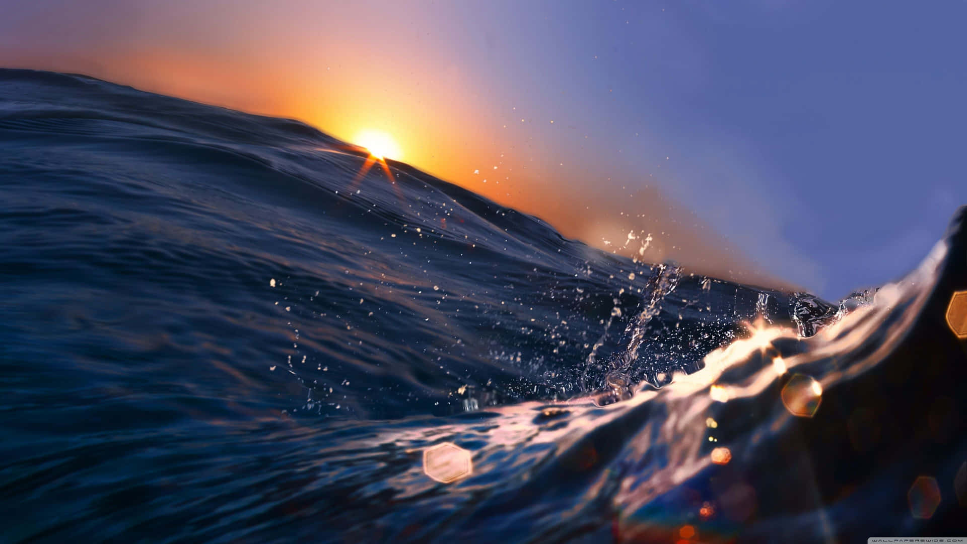 A Sunset Over The Ocean With Waves Wallpaper