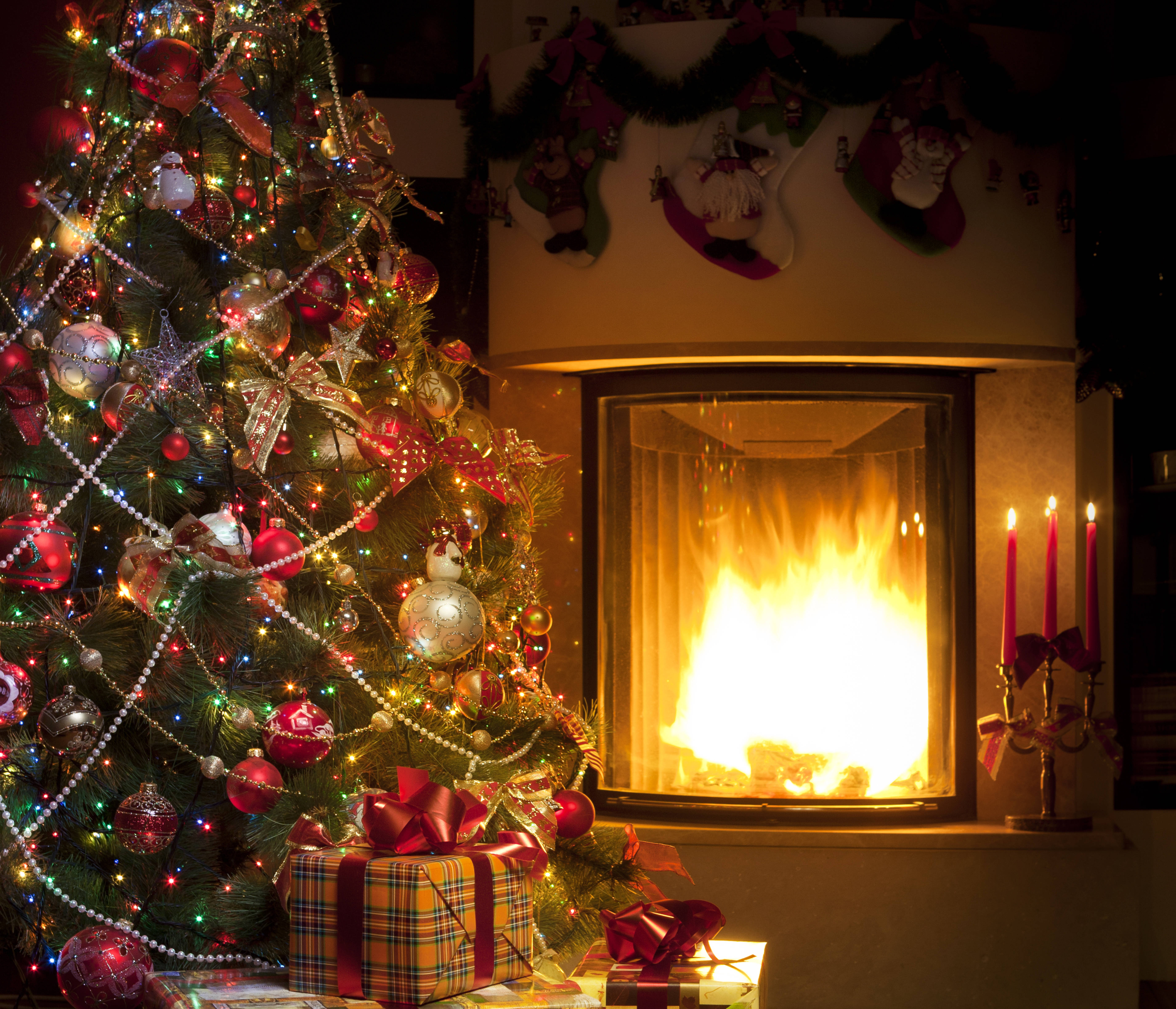 Enchanting Fireplace Christmas Setup on a Cool Winter Night Wallpaper