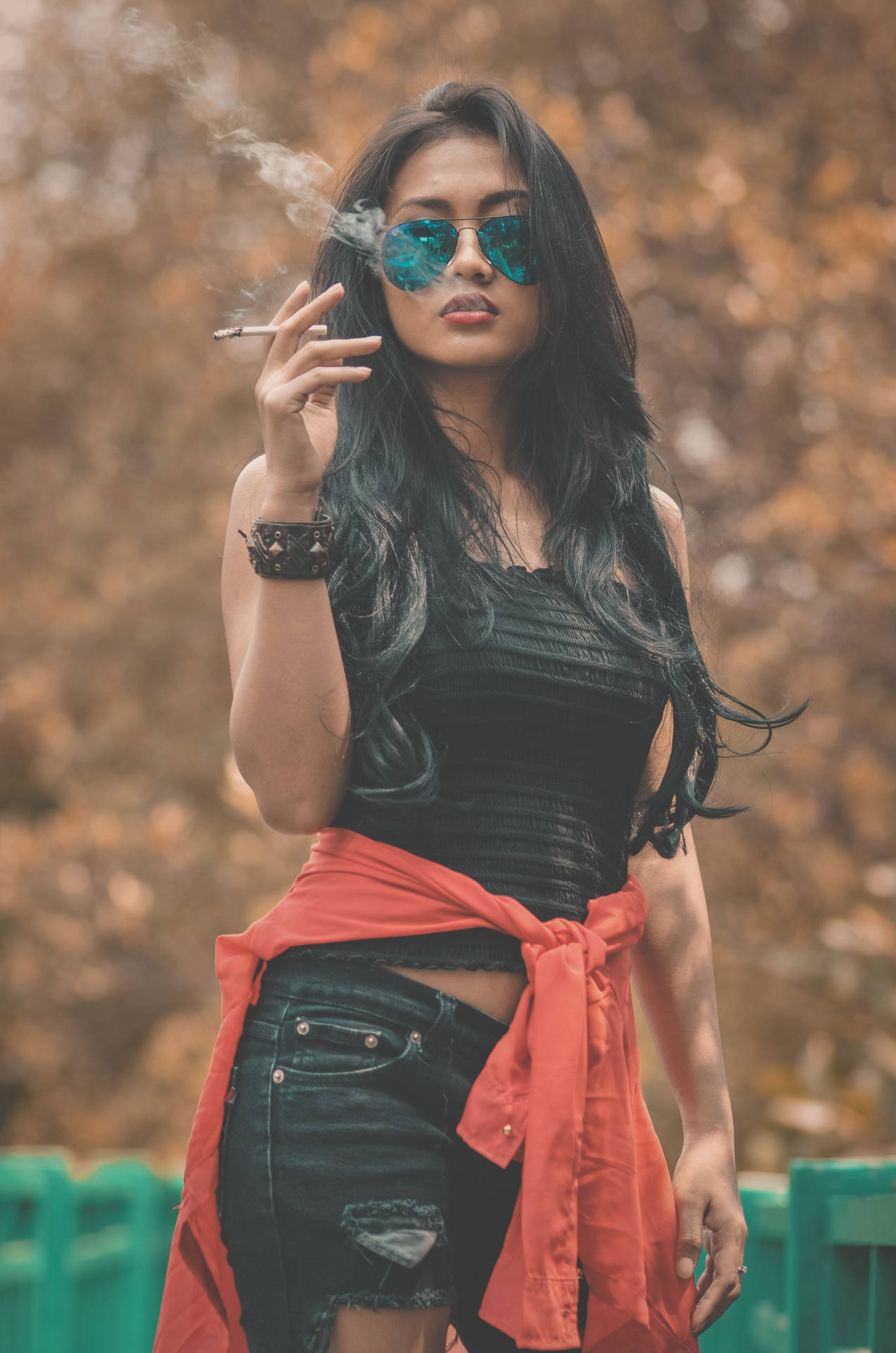 Cool Attitude Girl Smoking And Wearing Sunglasses Background