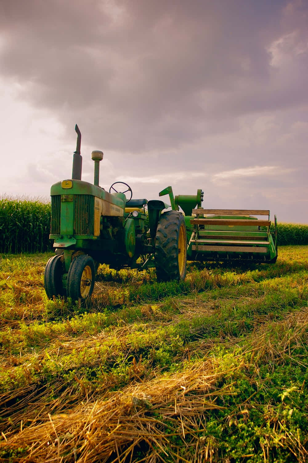 A Green Tractor In A Field Wallpaper