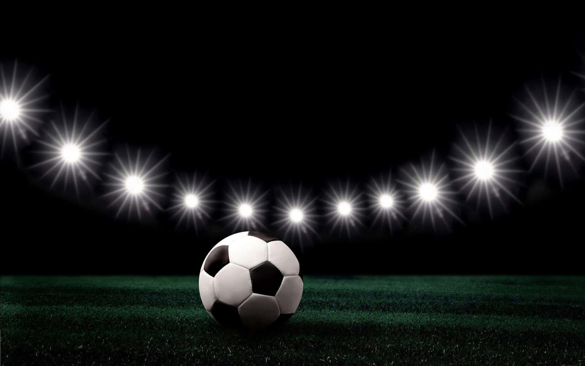 A Soccer Ball On A Field With Lights