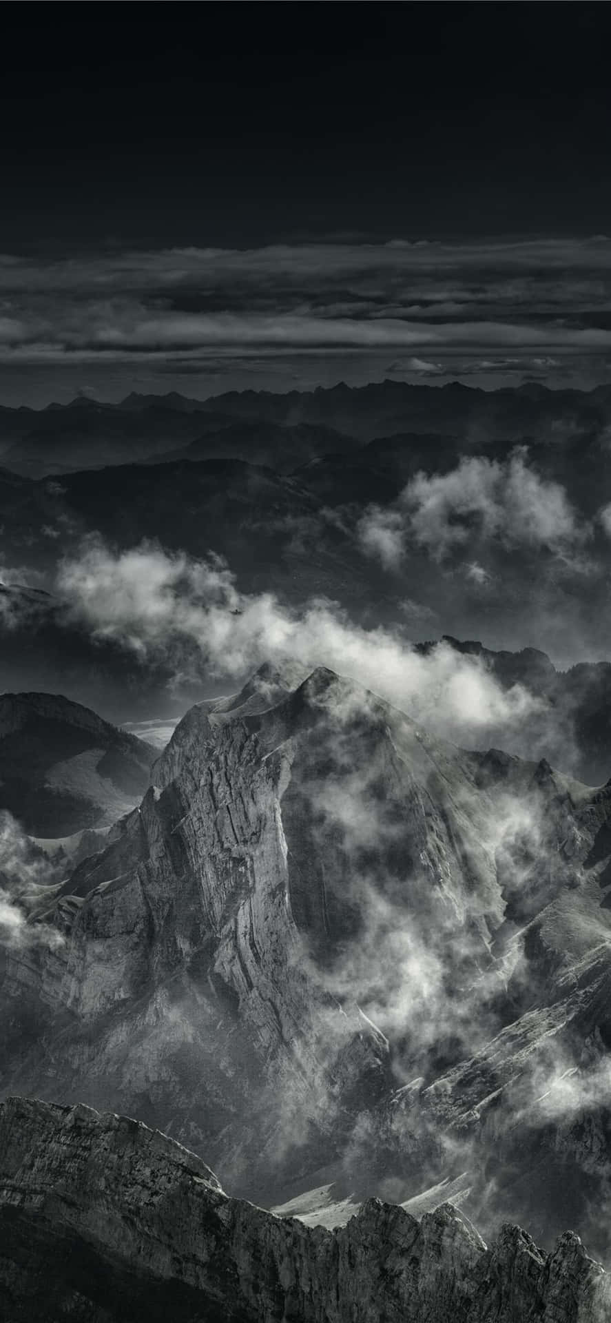 Download A Black And White Photo Of Clouds Over A Mountain ...