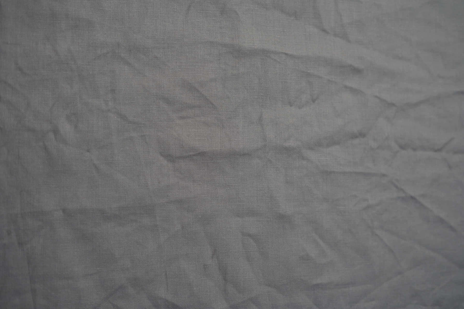 A Close Up Of A Grey Fabric Wallpaper