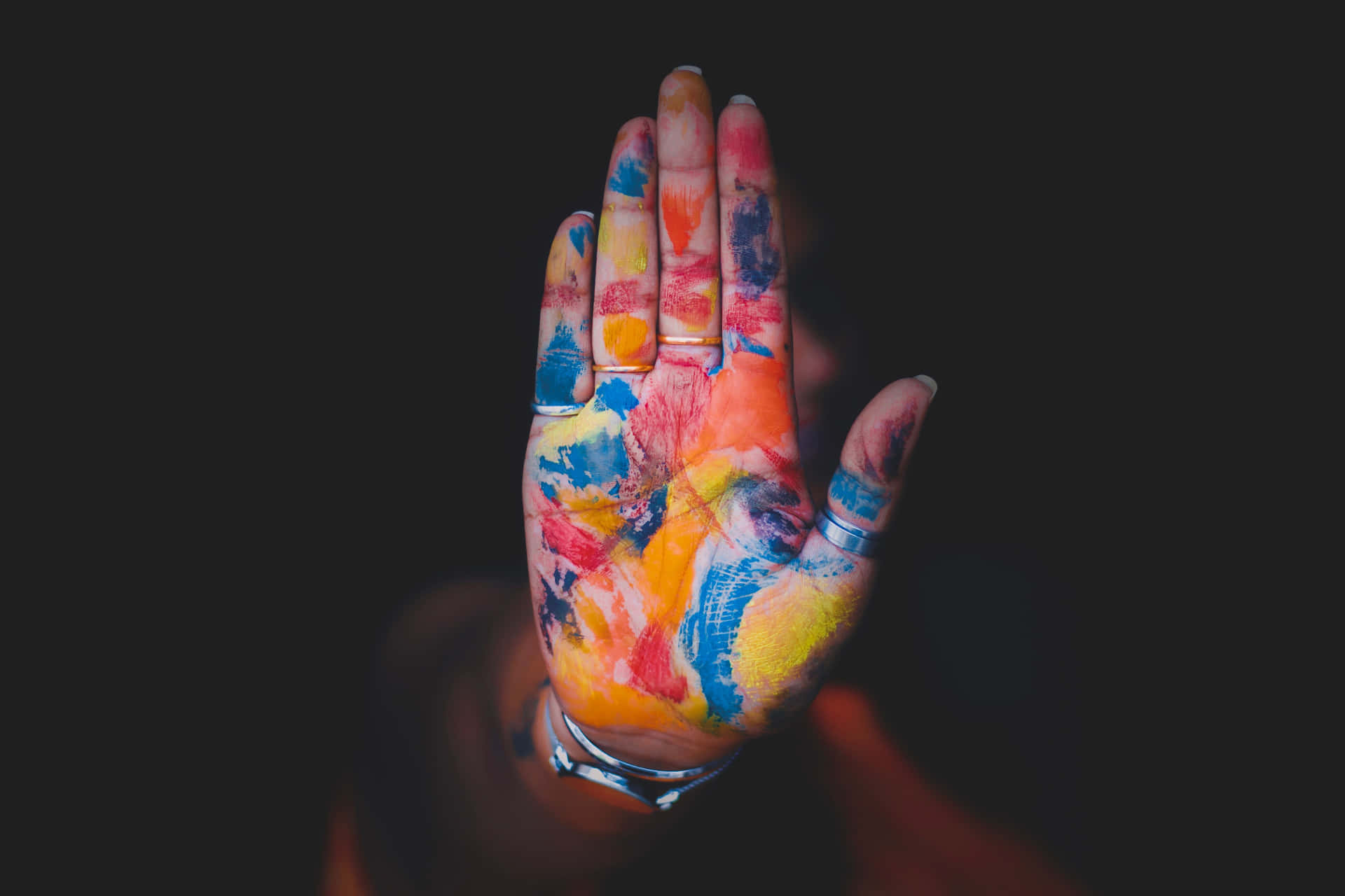 A Hand With Colorful Paint On It Wallpaper