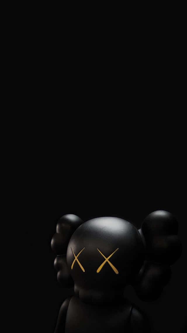 A Black Toy With A Yellow Cross On It Wallpaper