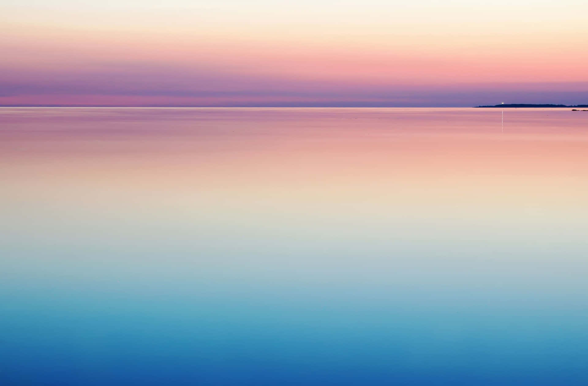 A Sunset Over A Calm Body Of Water Wallpaper