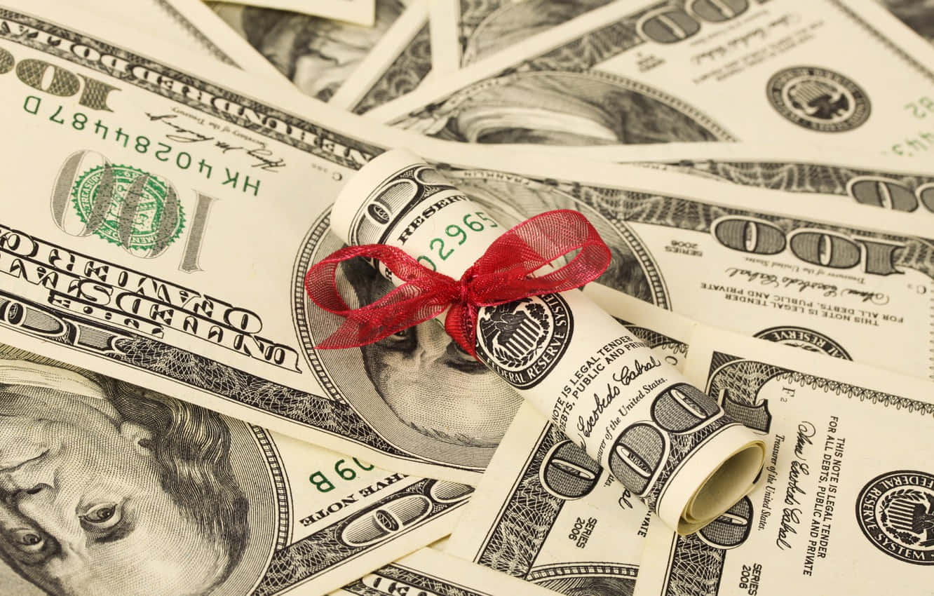 Et rødt bånd er bundet omkring en bunke penge Wallpaper