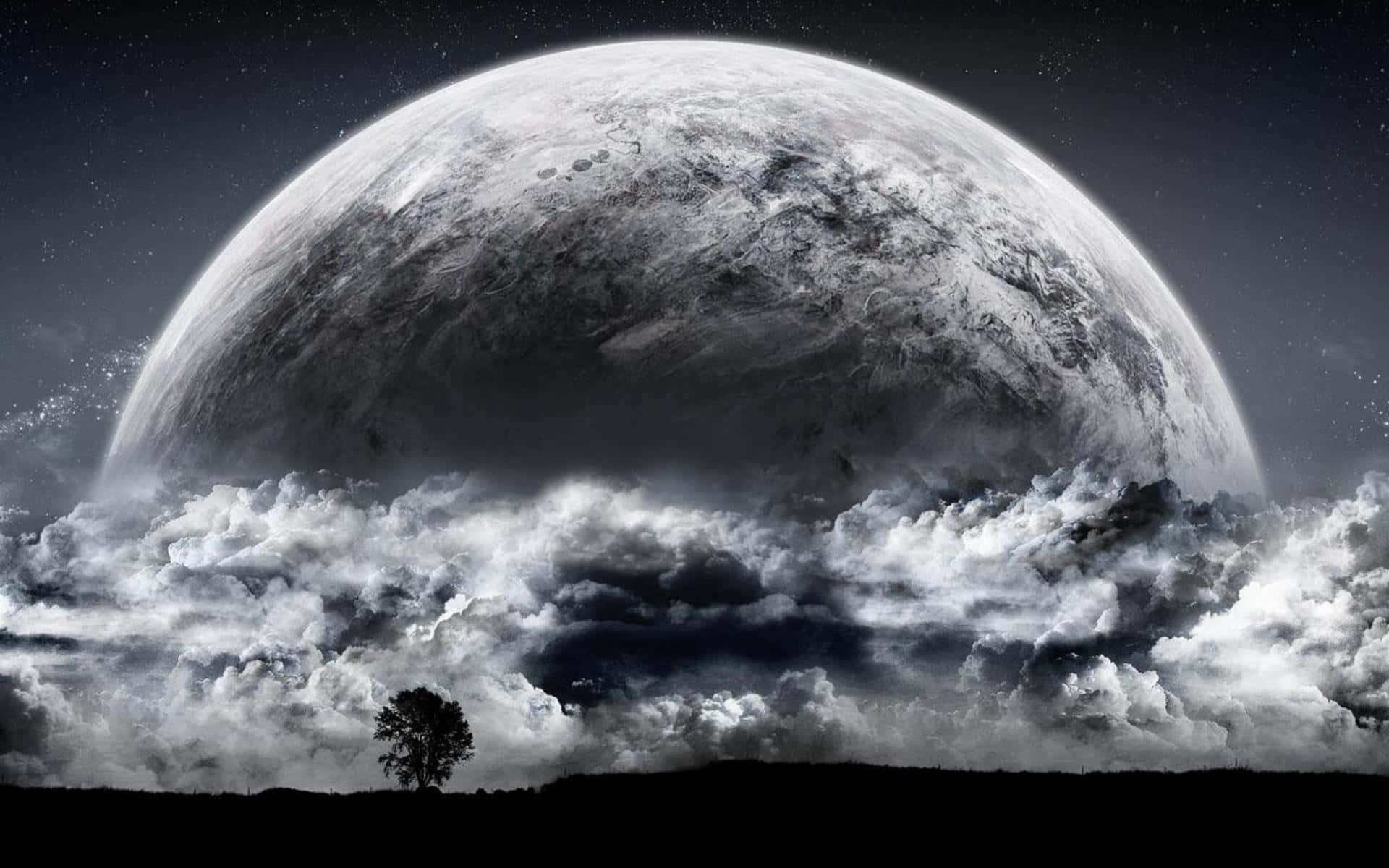 A Moon With Clouds And A Tree In The Background Wallpaper