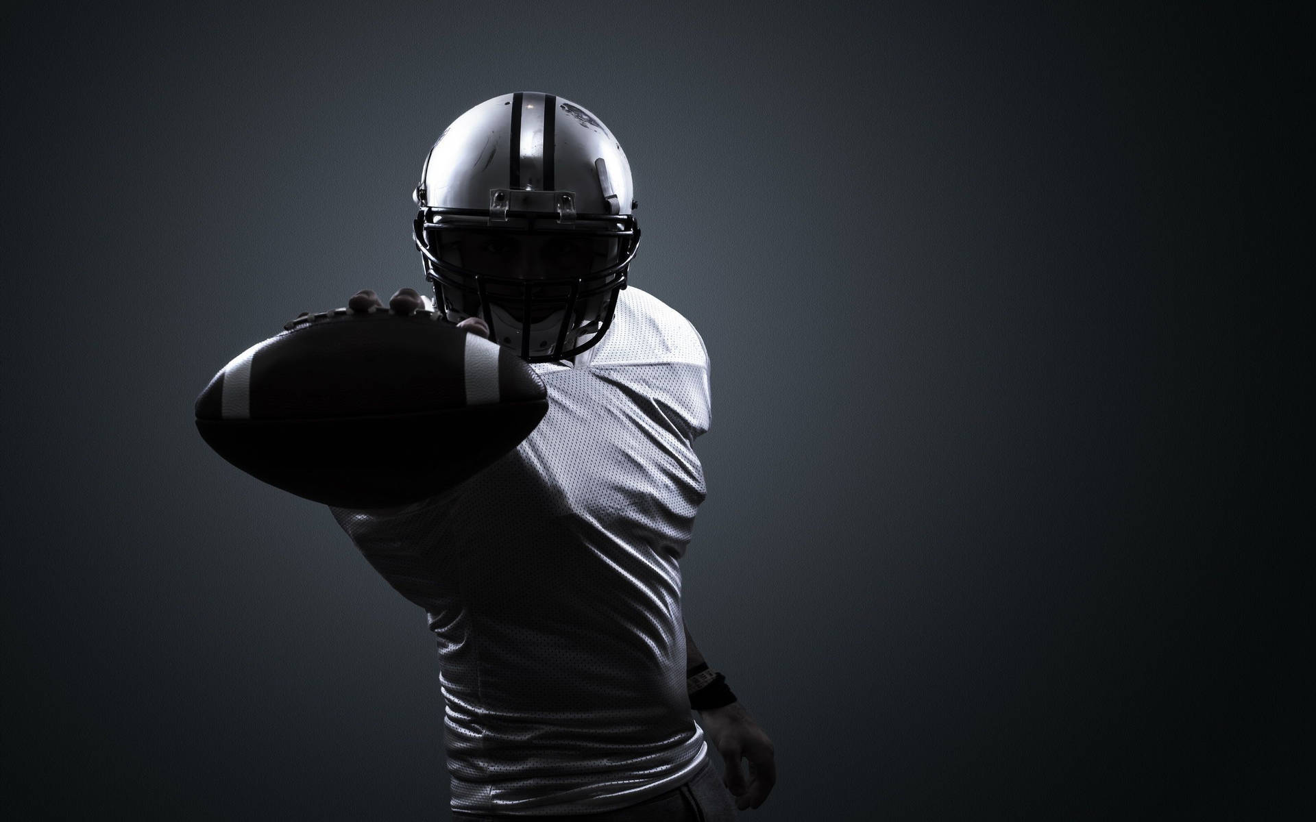 American Football Sportsman Player In Helmet On Black Background With  Smoke. Sport And Motivation Wallpaper. Stock Photo, Picture And Royalty  Free Image. Image 128095867.