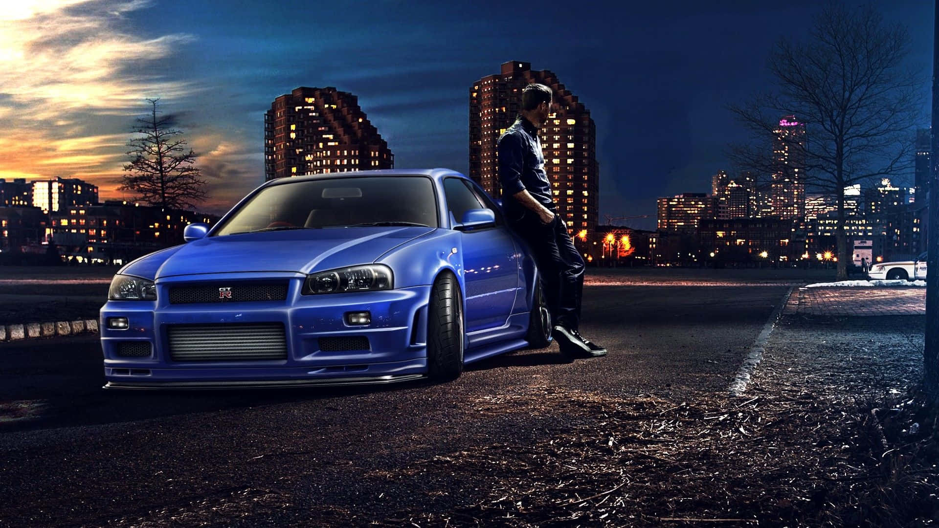 Cool Nissan Skyline With A Man Leaning On Its Side Wallpaper