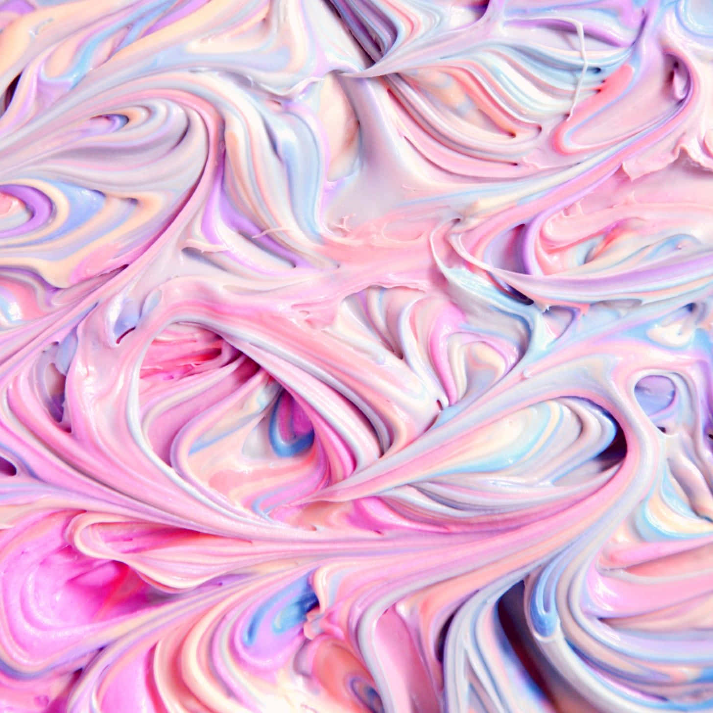 A Close Up Of A Pink And Blue Swirled Liquid