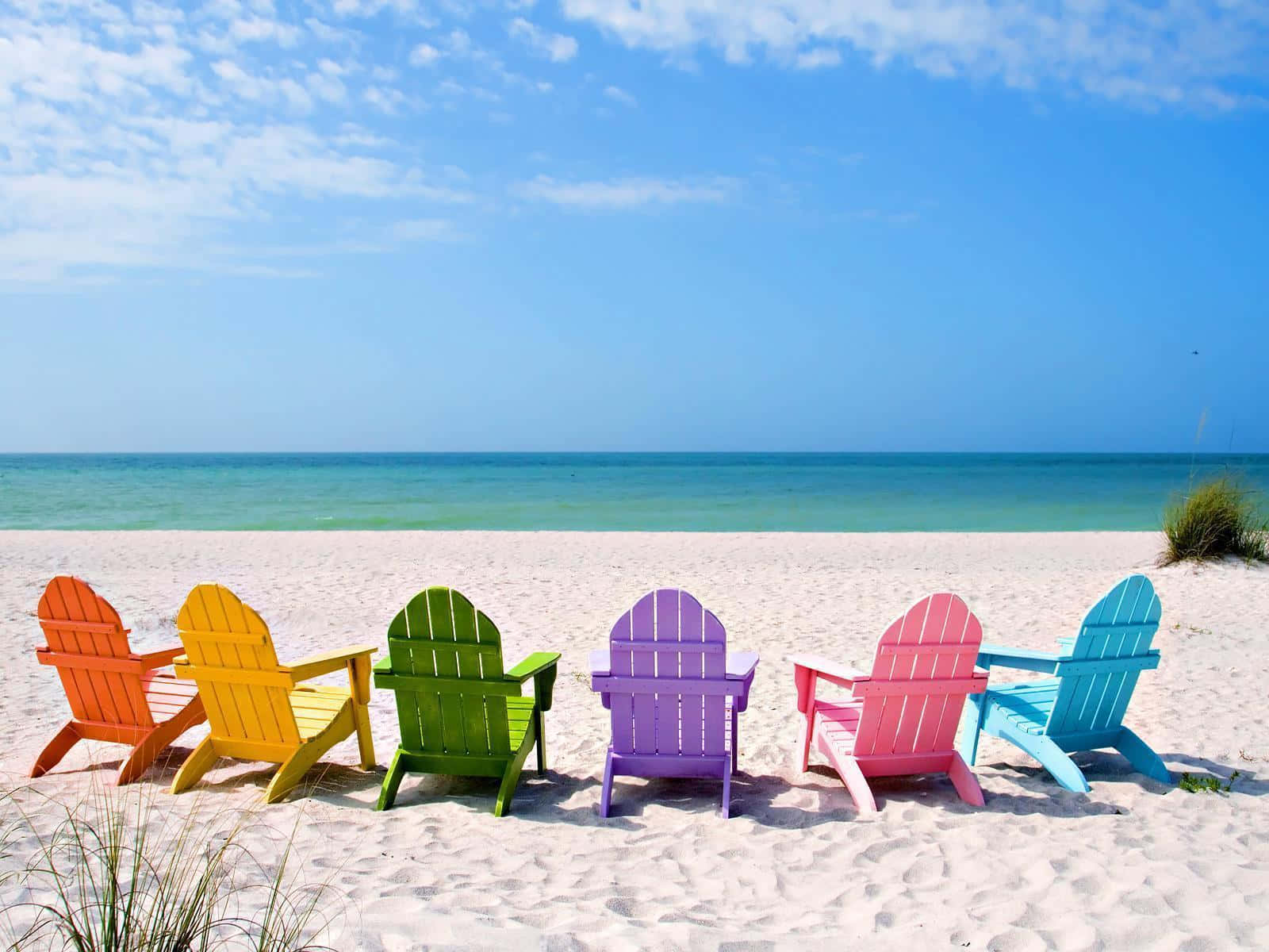 Cool Summer Beach With Colorful Lounge Chairs Wallpaper