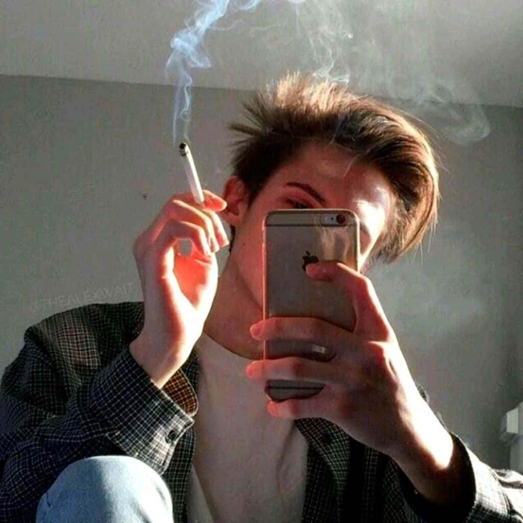 Enman Som Röker En Cigarett Medan Han Håller Sin Mobiltelefon