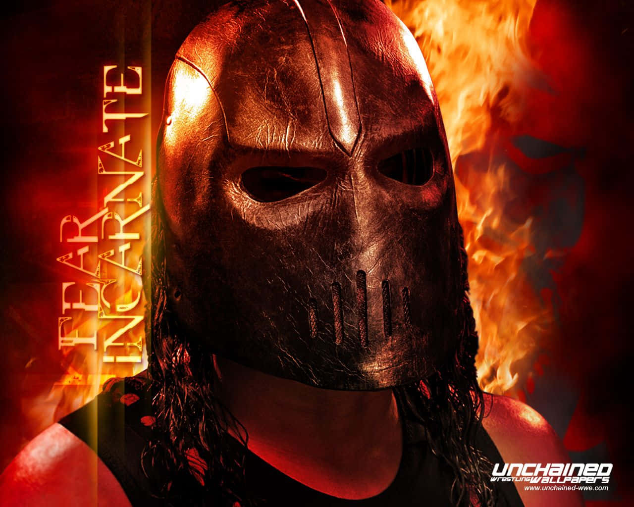 A Man In A Mask With Flames Behind Him Wallpaper