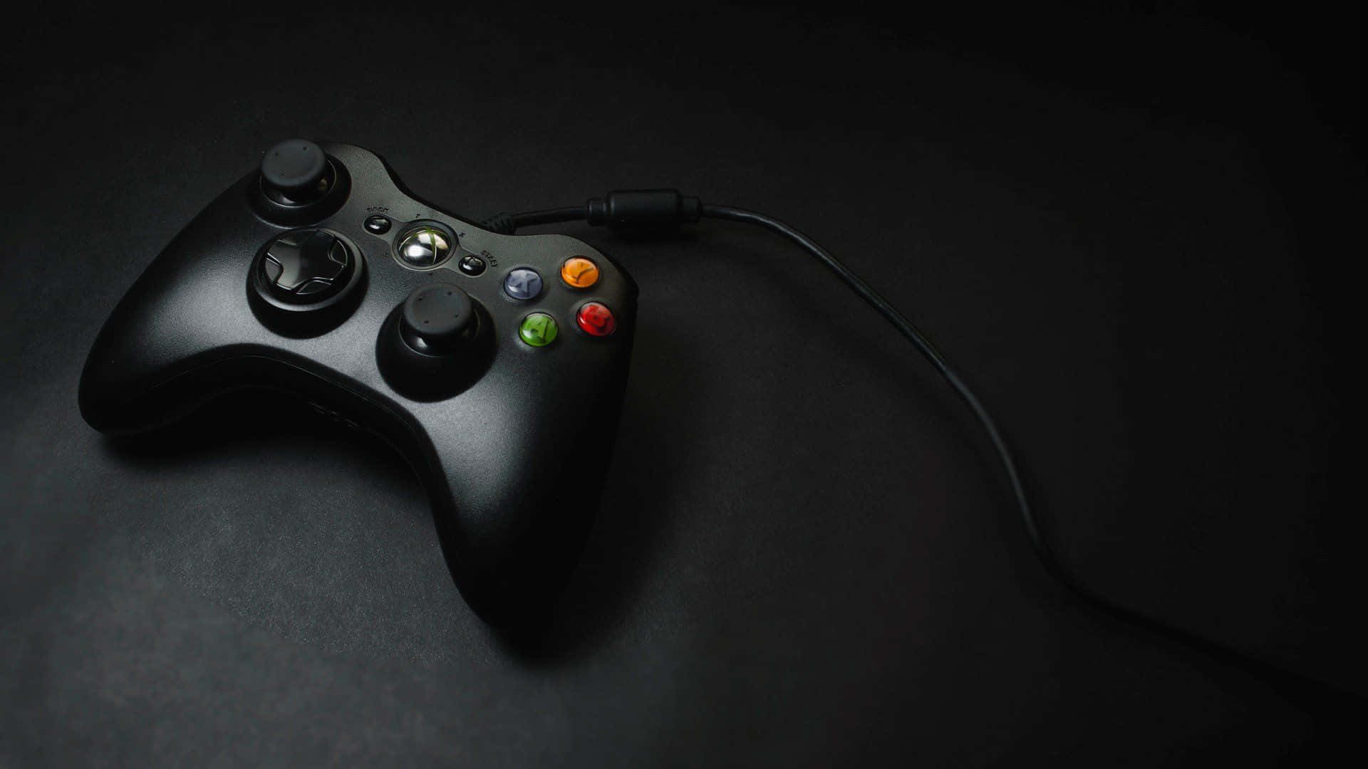 A Black Xbox Controller On A Black Surface Wallpaper