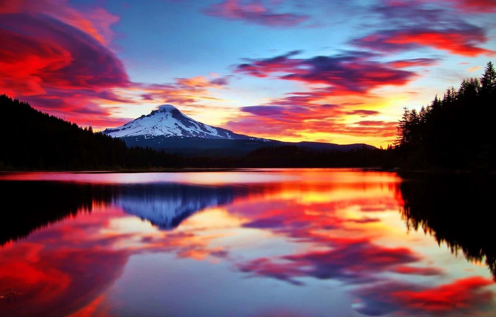 A Mountain Is Reflected In A Lake At Sunset