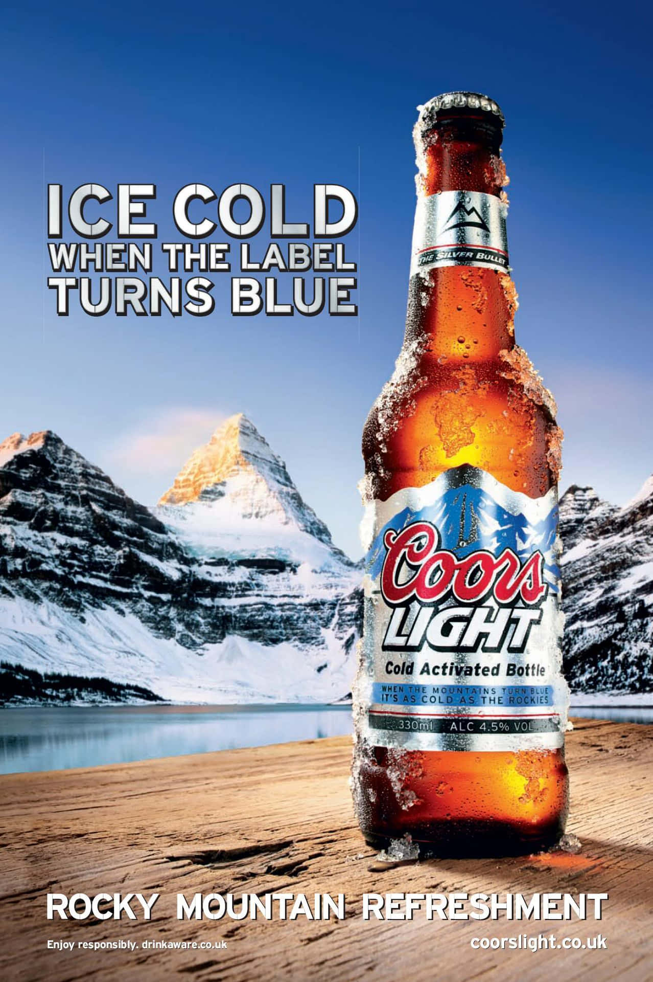 A Beer Advertisement With The Words Ice Cold When It Turns Blue Wallpaper