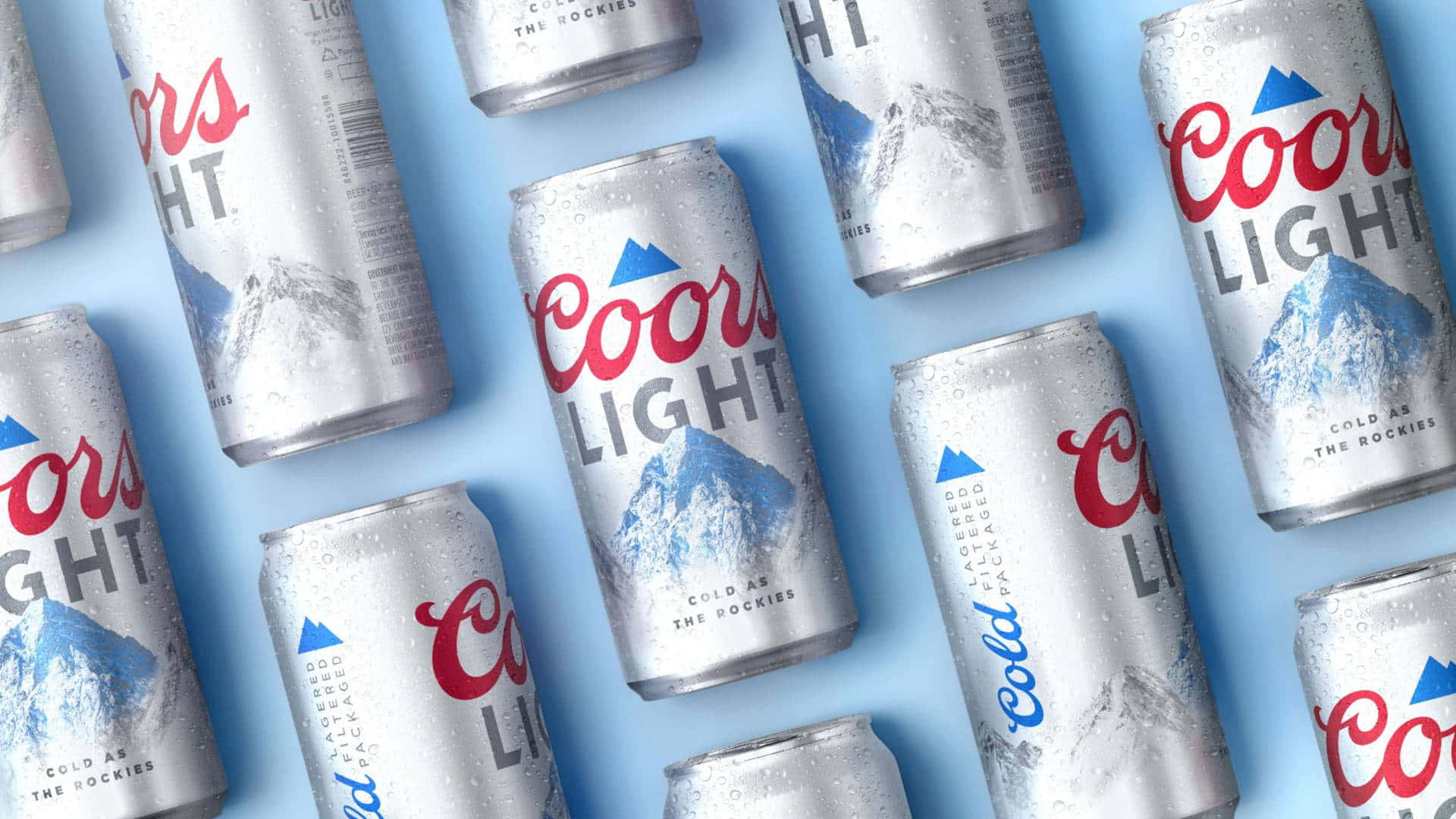 A Group Of Cans Of Coors Light Are Arranged On A Blue Surface Wallpaper