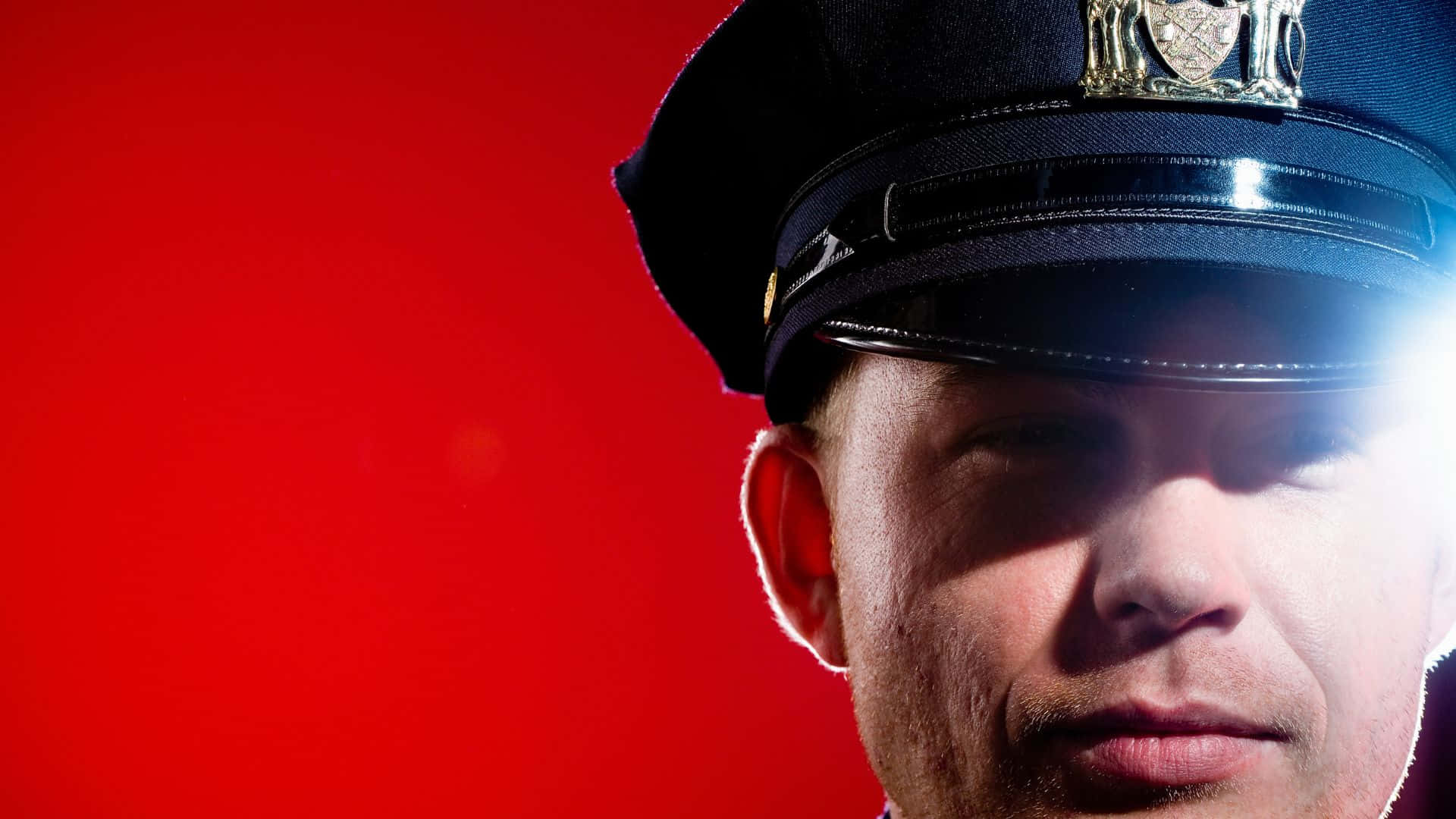 Close Up View Of Cop Officer In Red Background Wallpaper