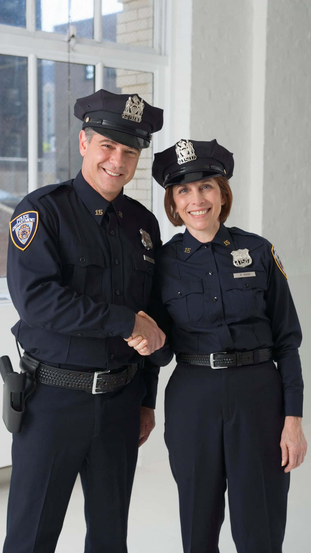 Two Cop Smiling And Shaking Hands Wallpaper