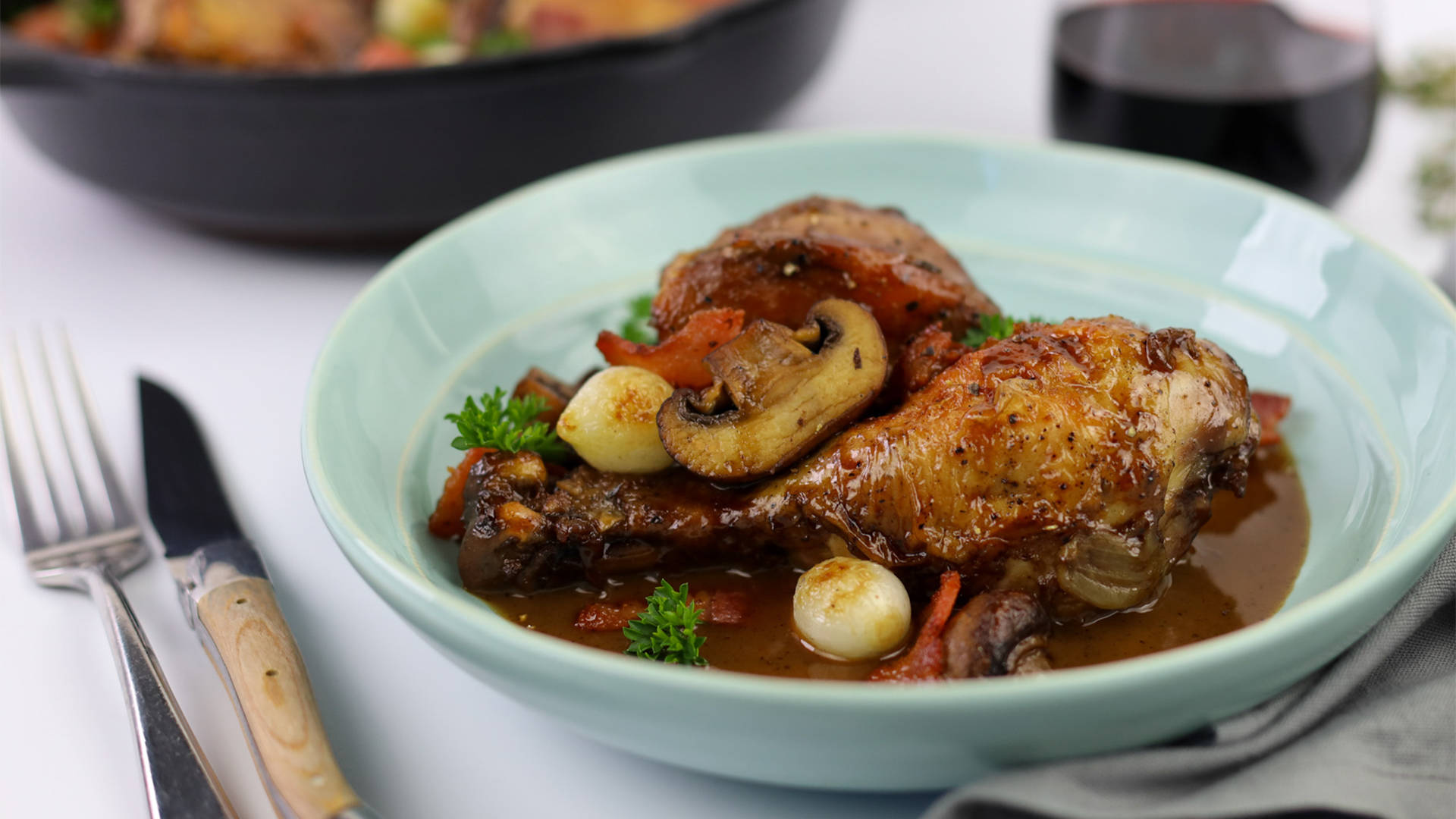 Coq Au Vin On A Ceramic Plate With Cutlery Wallpaper
